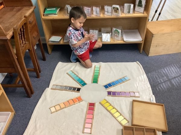 Child learning to use a hammer