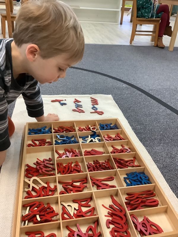 Child learning to use a hammer