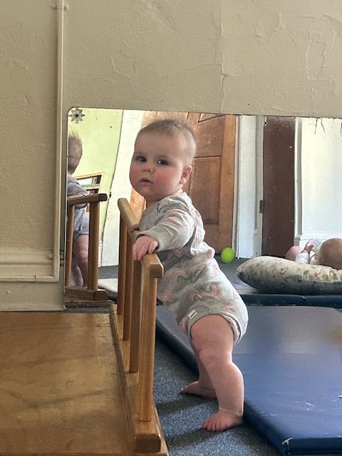 Infant playing with wooden toy