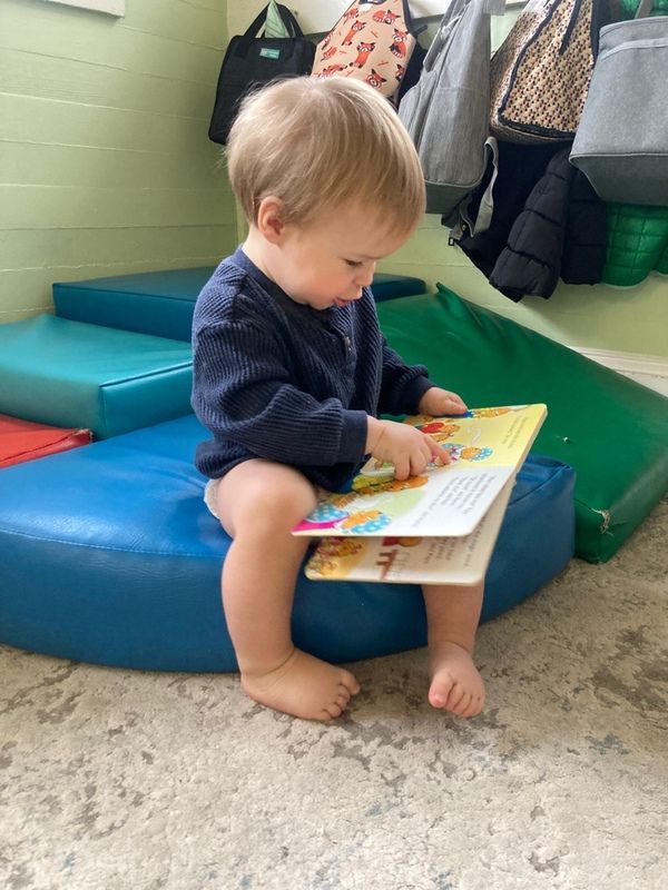 Infant playing with wooden toy