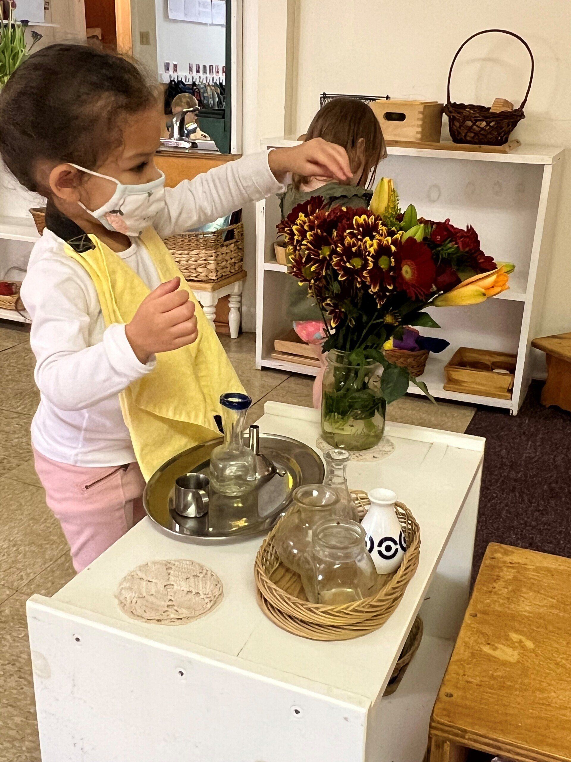 Child working with practical life materials
