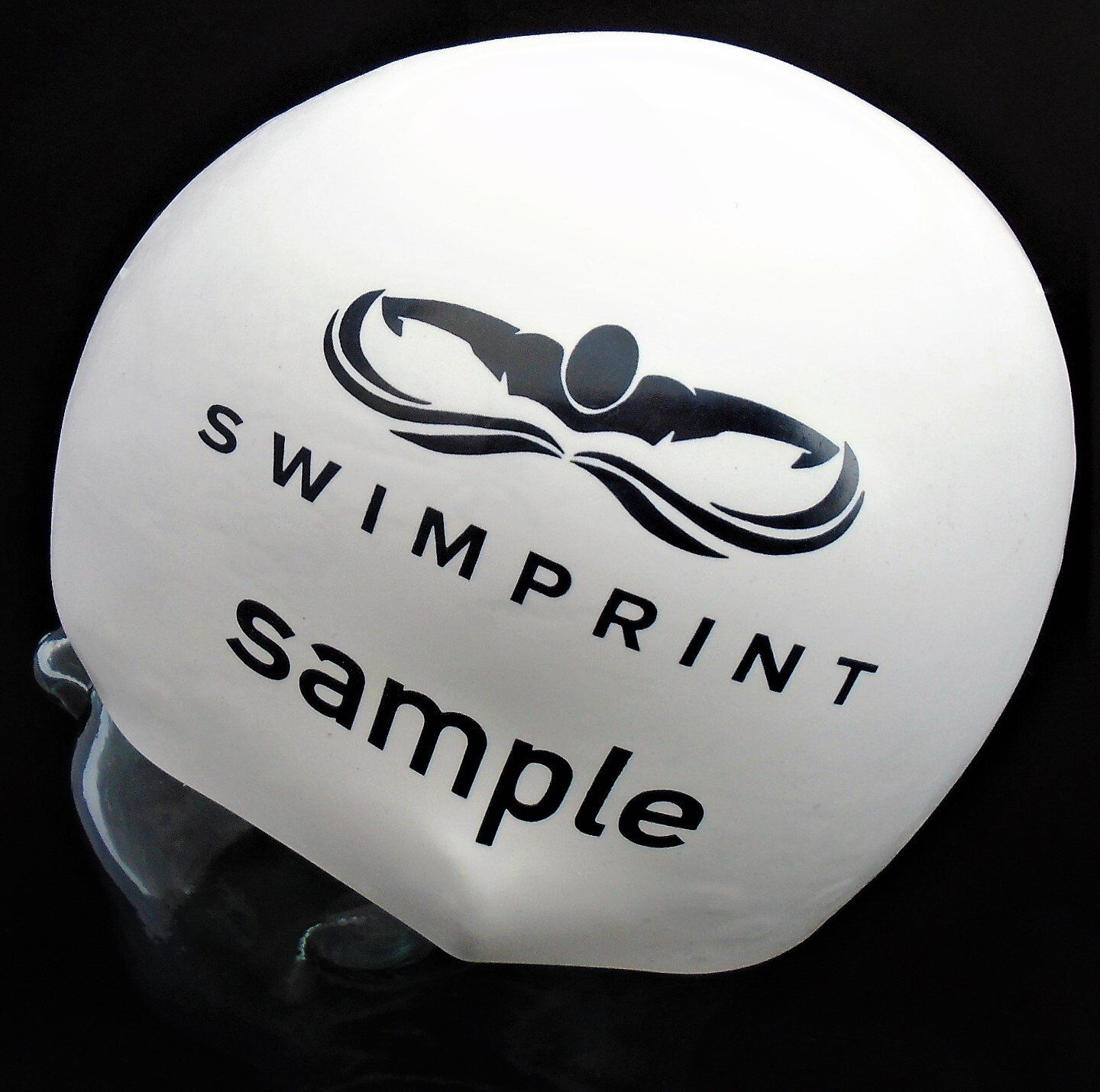 A white swim cap that says swimprint sample on it