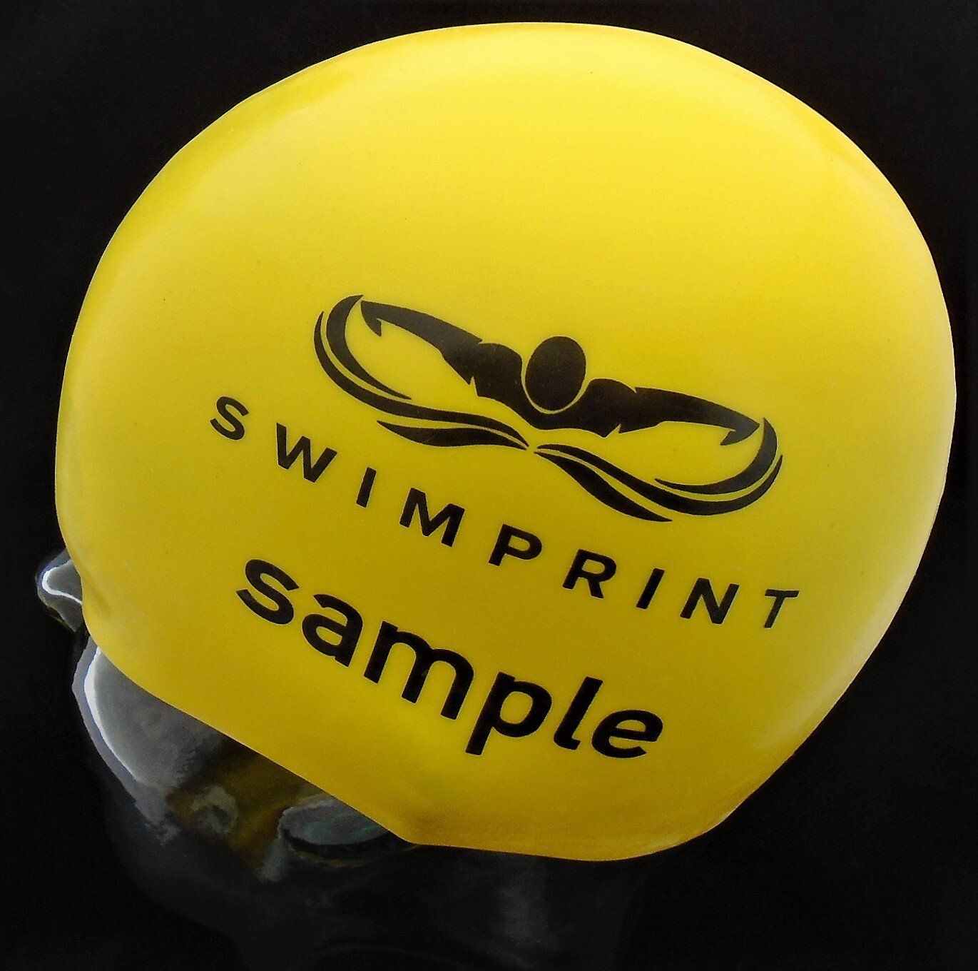 A yellow swim cap that says swimprint sample on it