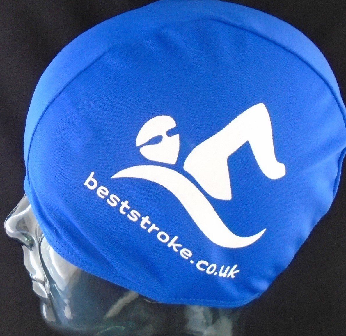 A blue swim cap that says beststroke.co.uk on it