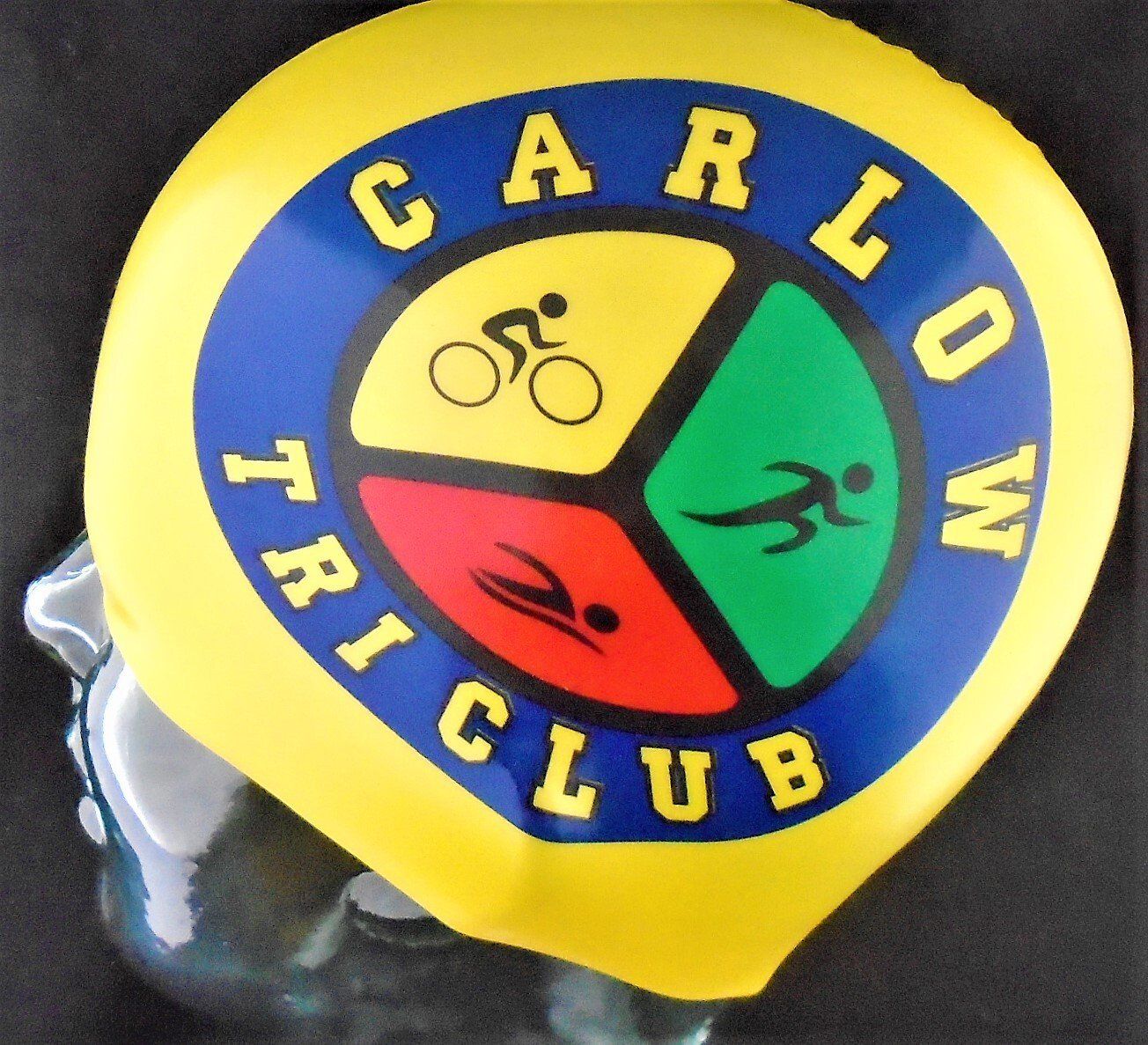 A yellow swim cap that says carlo w tri club