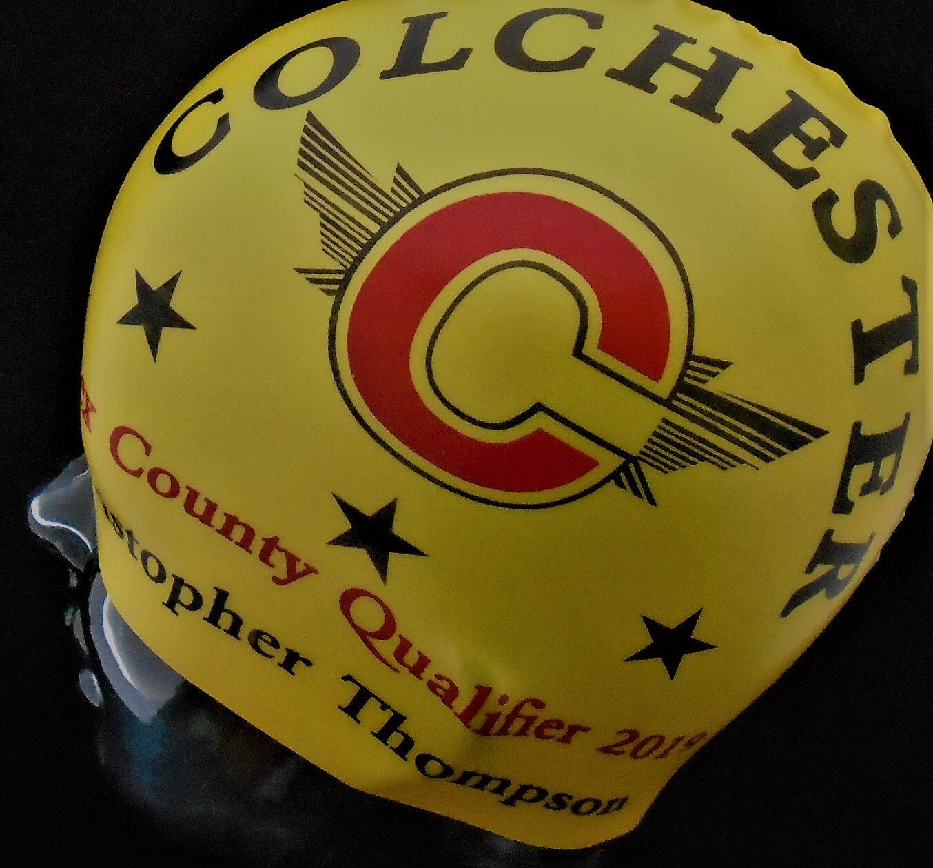 A yellow colchester county qualifier swimming helmet