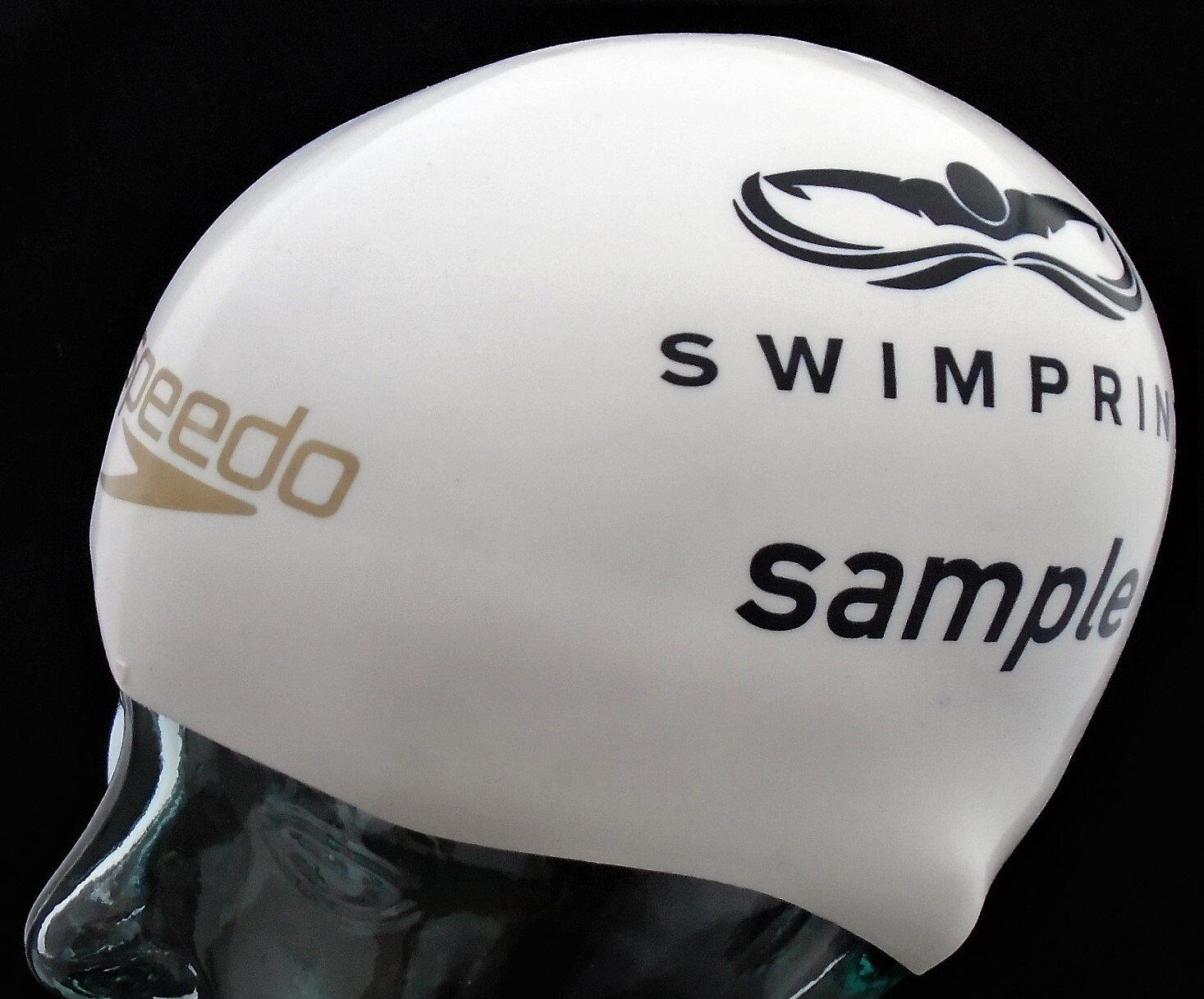 A white speedo swim cap is on a mannequin head