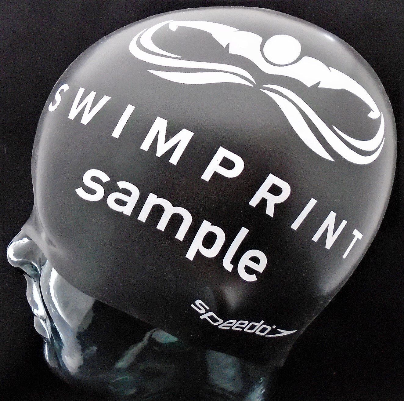 A black swim cap that says swim print sample on it
