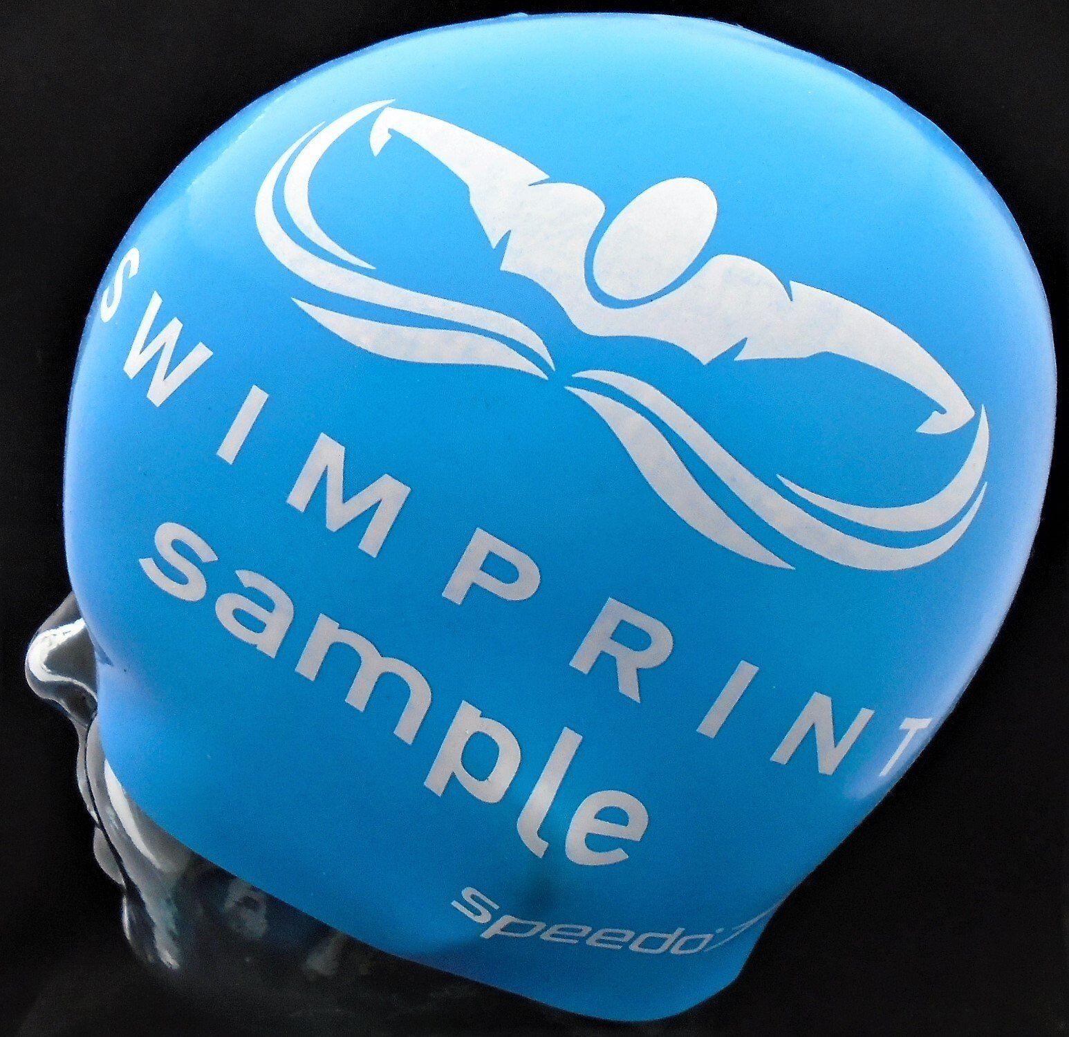 A blue swim cap that says ' swimprint sample ' on it