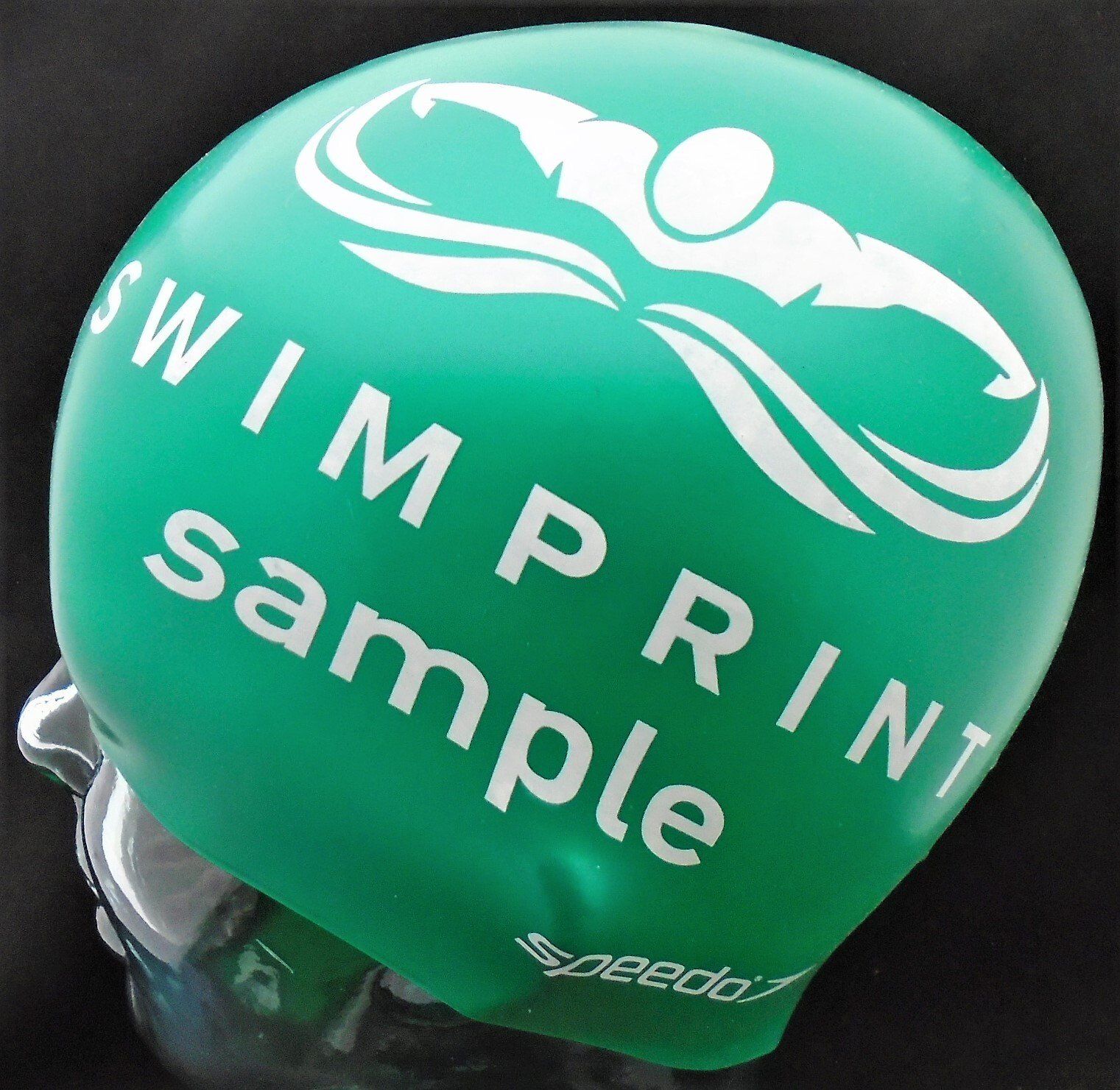 A green swim cap that says swim print sample on it