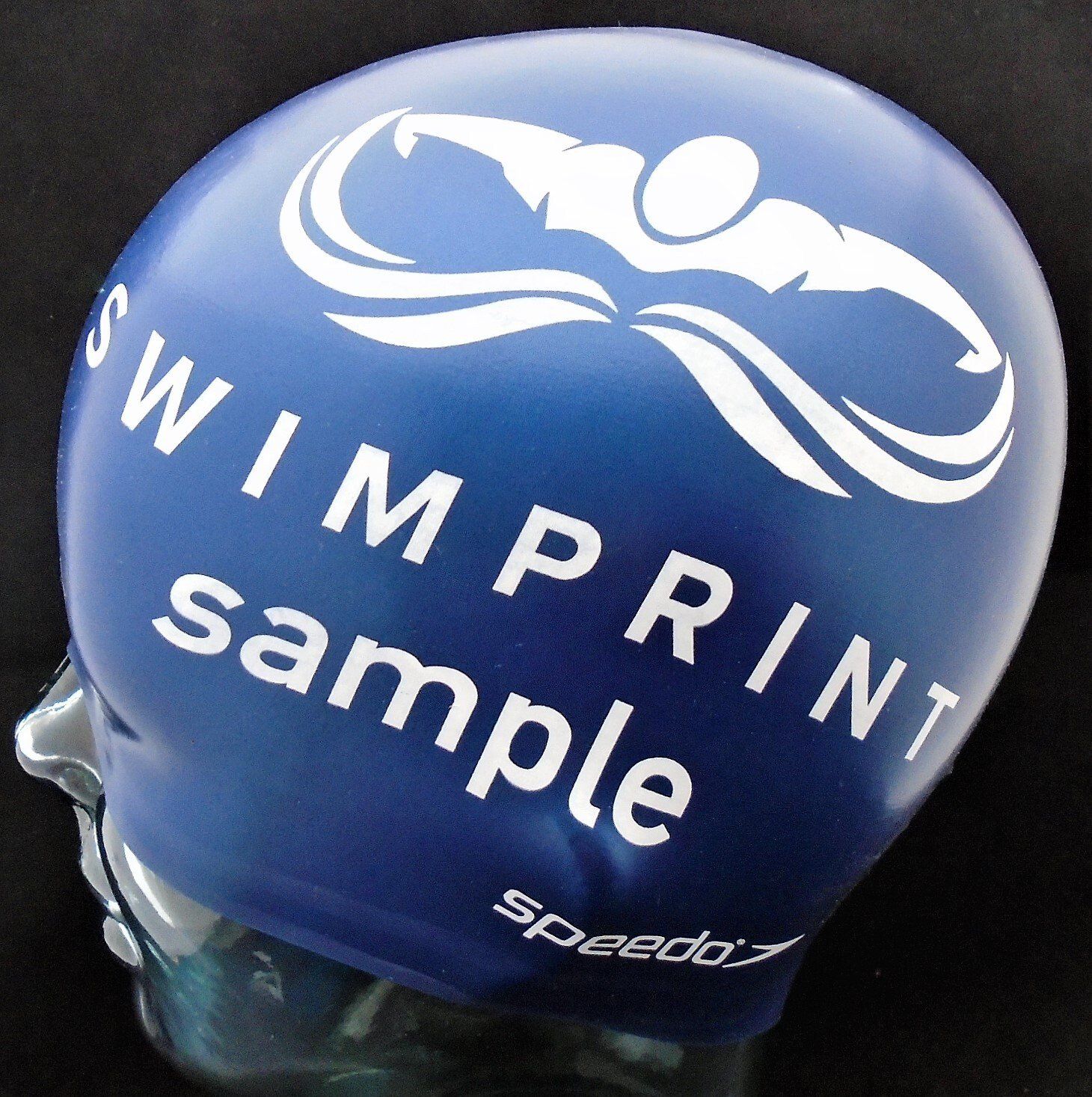 A blue swim cap that says ' swimprint sample ' on it