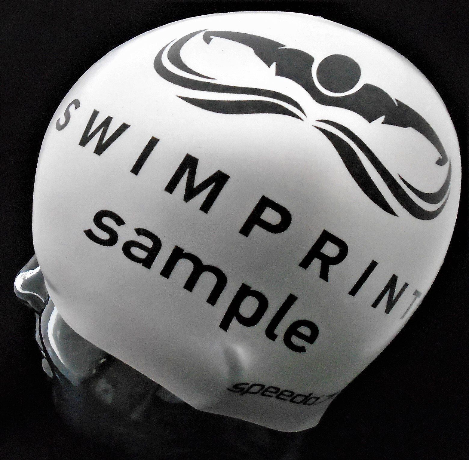 A white swim cap that says swimprint sample on it