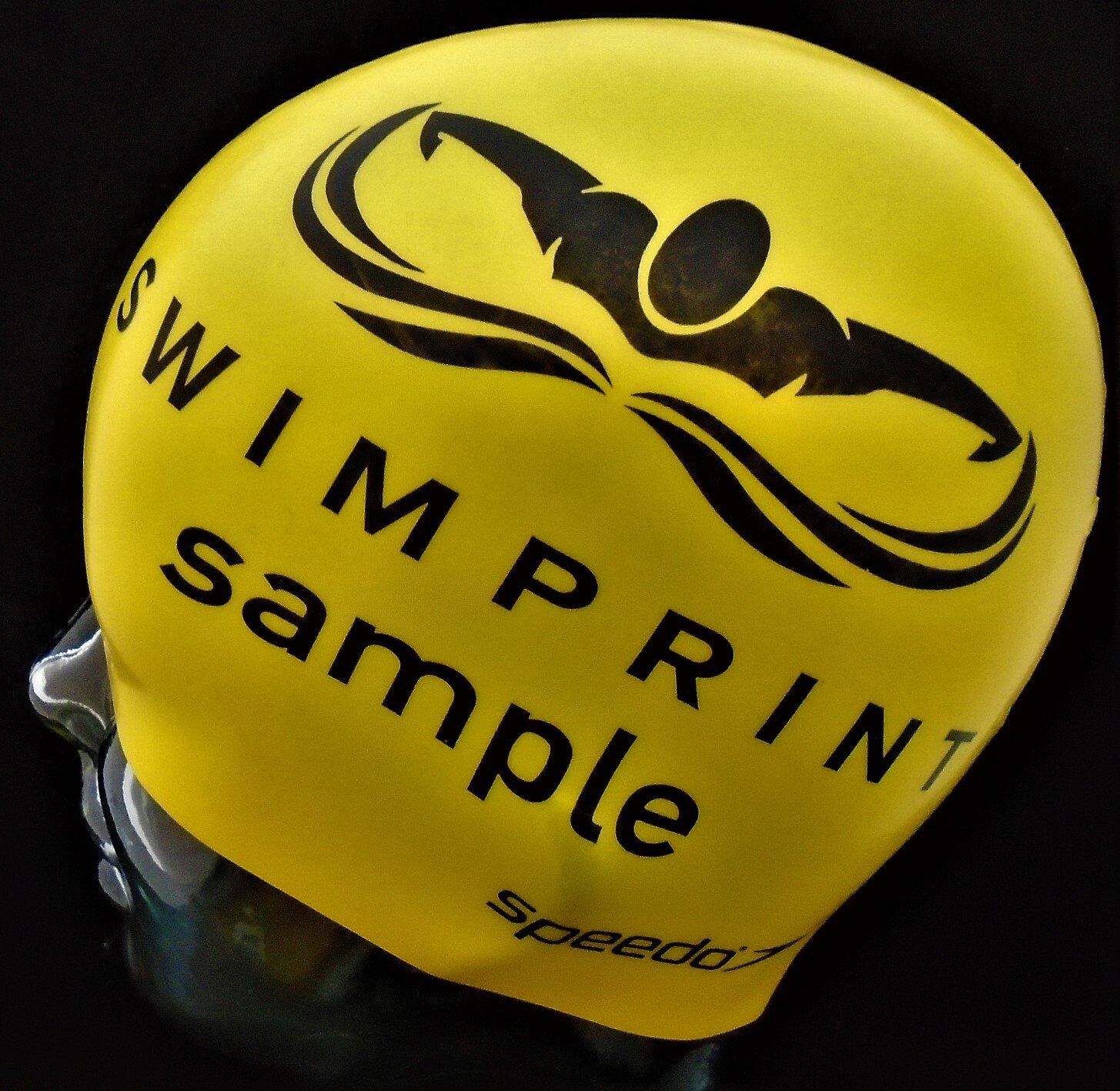 A yellow swim cap that says swimprint sample on it