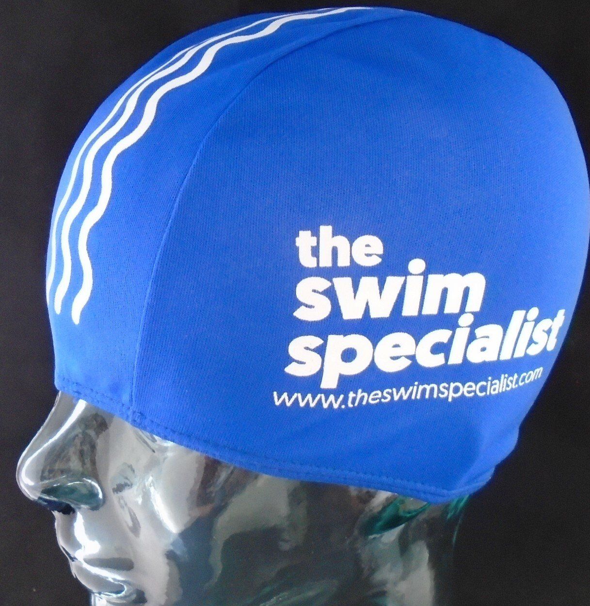 A blue swim cap that says the swim specialist on it