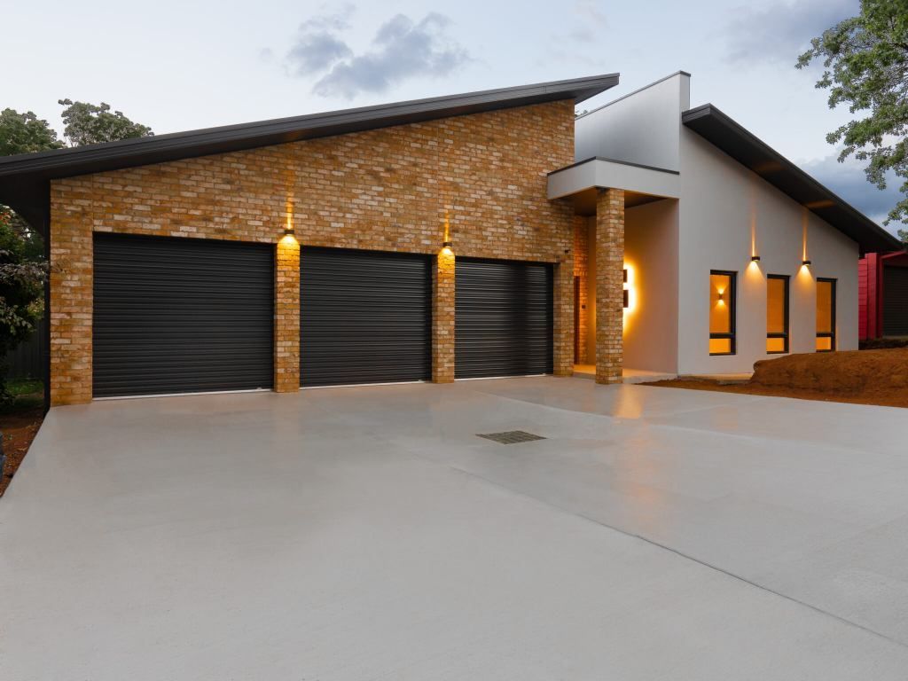 Grey coloured concrete driveway with smooth finishing surface completed in Launceston Tas