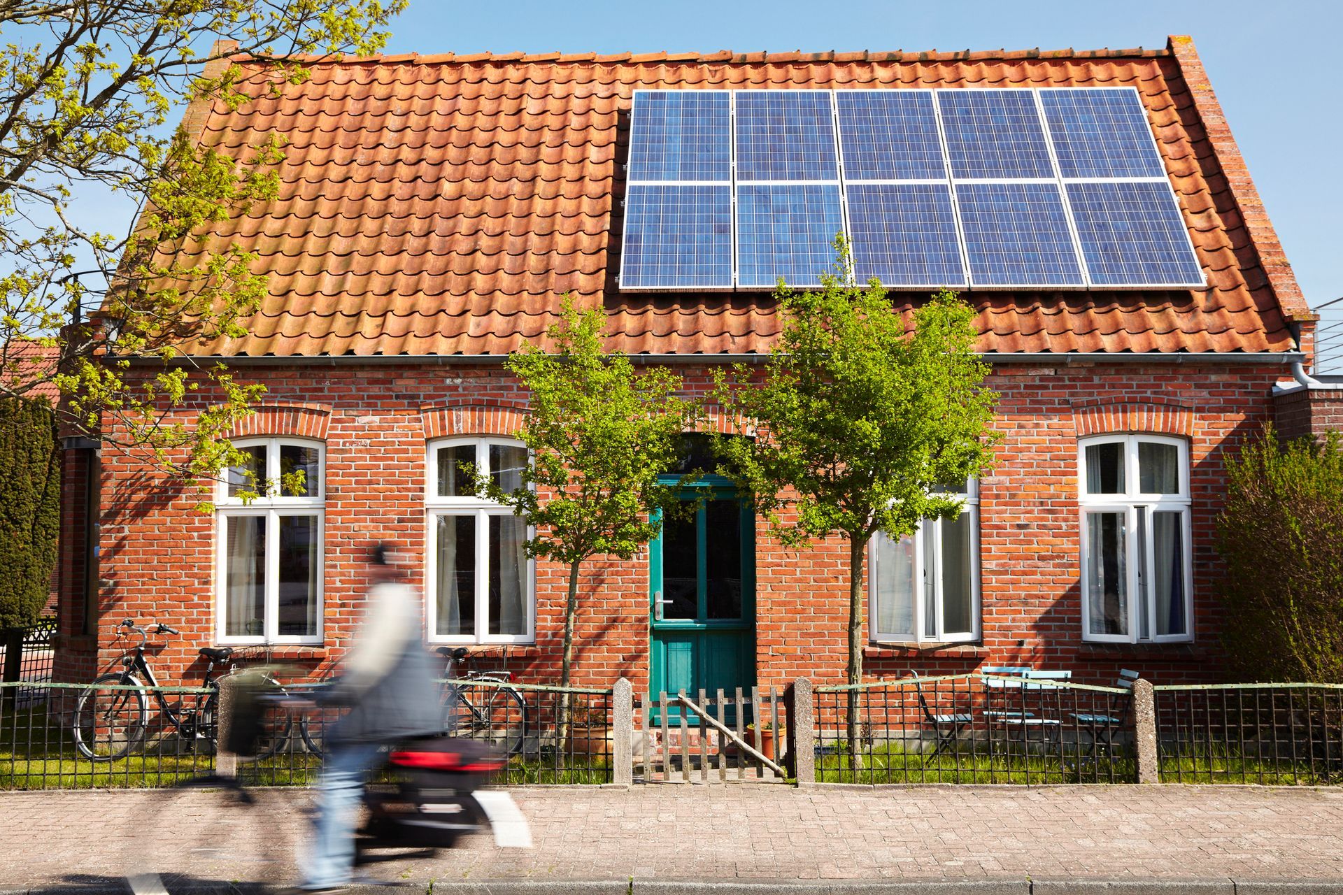 A brick house with solar panels on the roof