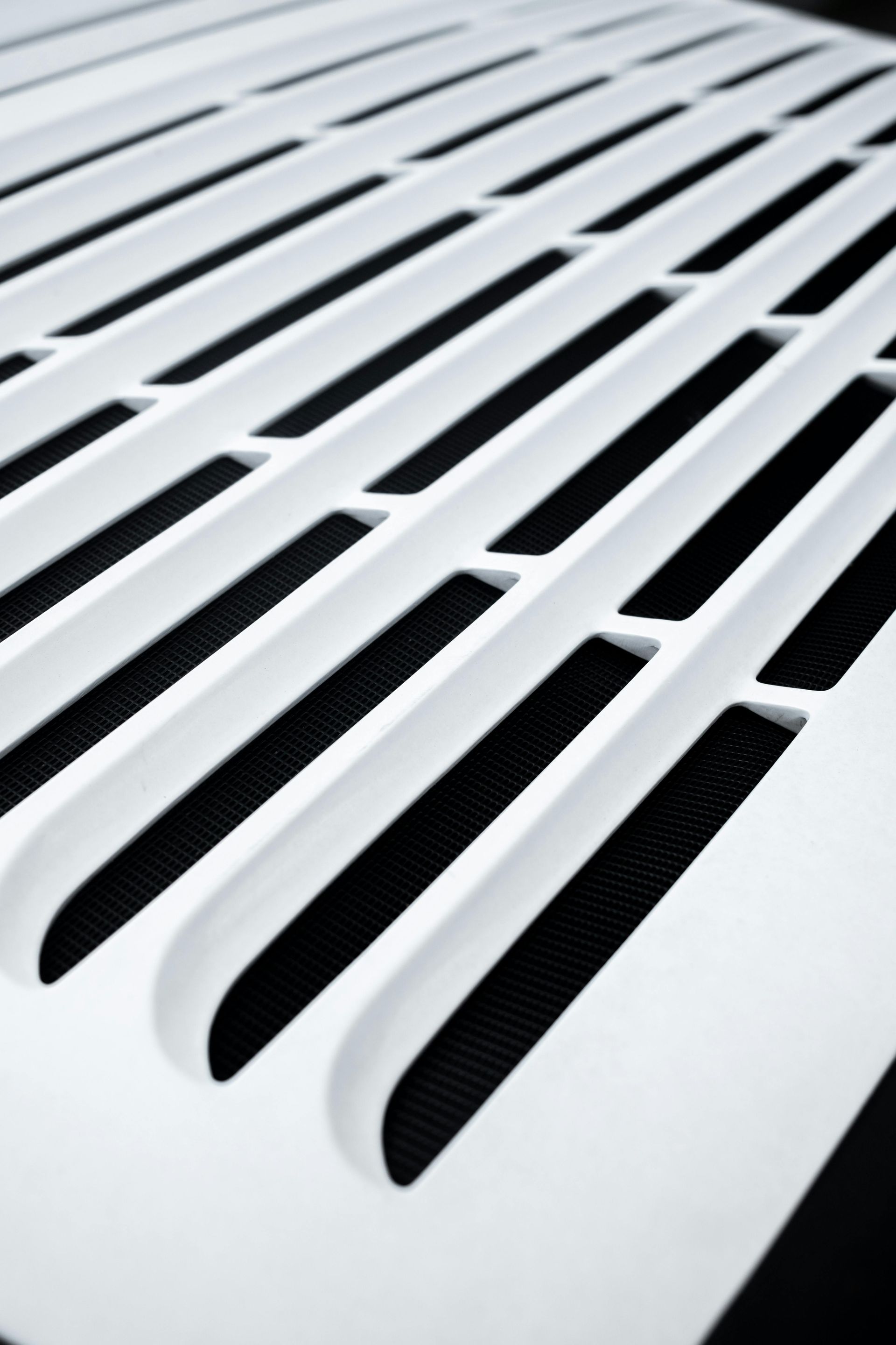 A close up of a white grille with black stripes