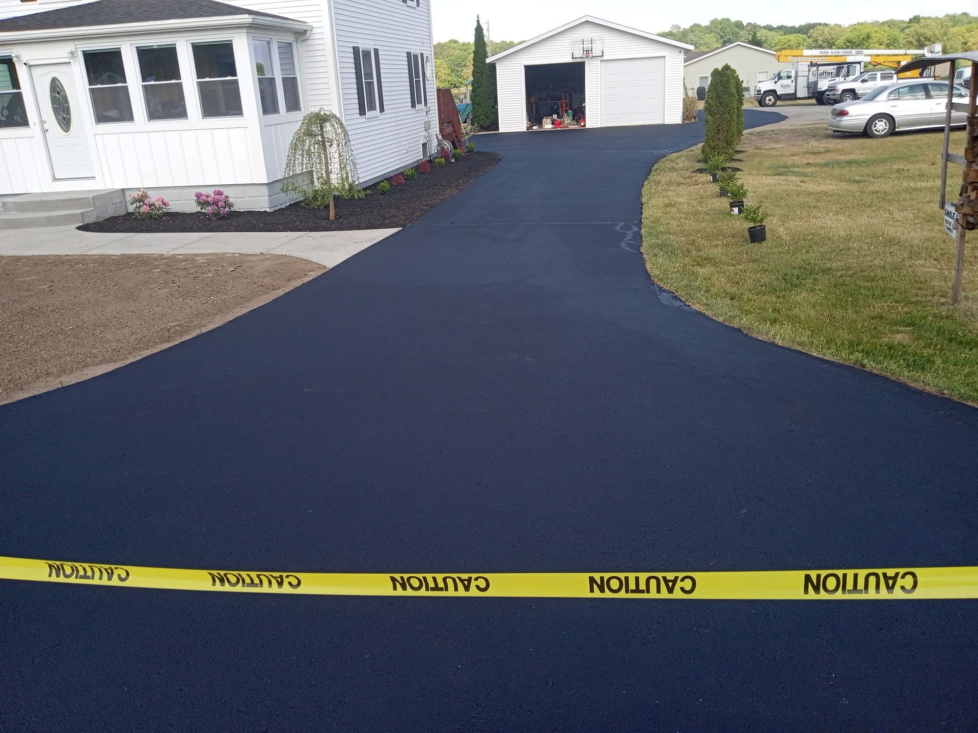 A driveway with a yellow caution tape on it