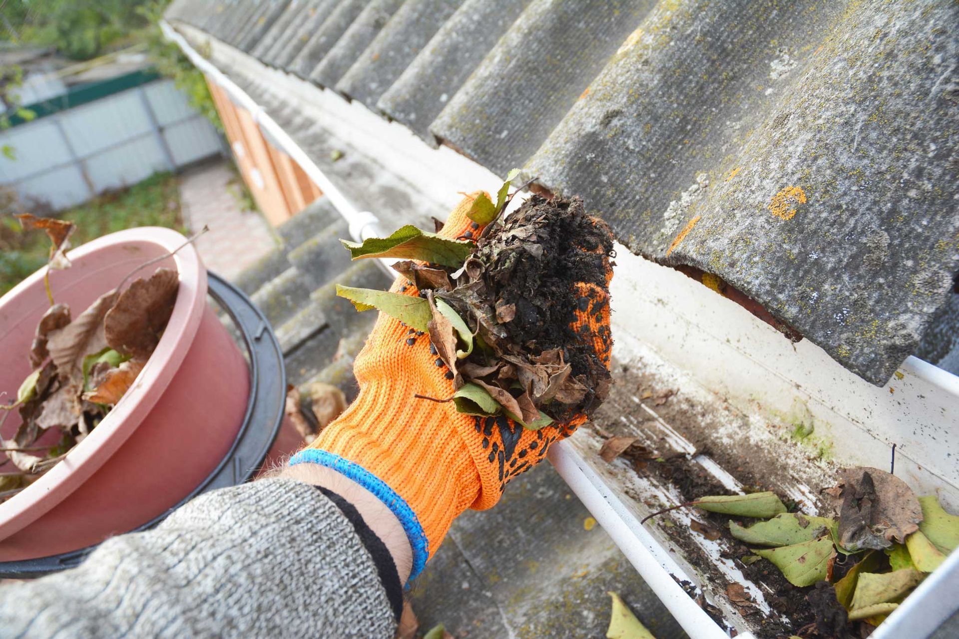 A man is holding the dirt he took from the gutters.