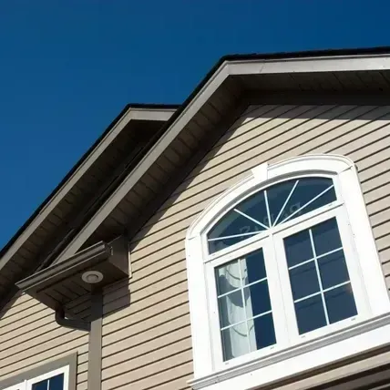Tan house exterior with a white arched window under a blue sky.