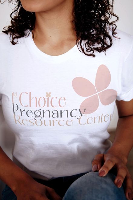 A woman wearing a white t-shirt that says choice pregnancy resource center