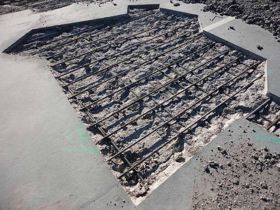 A large piece of concrete is laying on the ground.