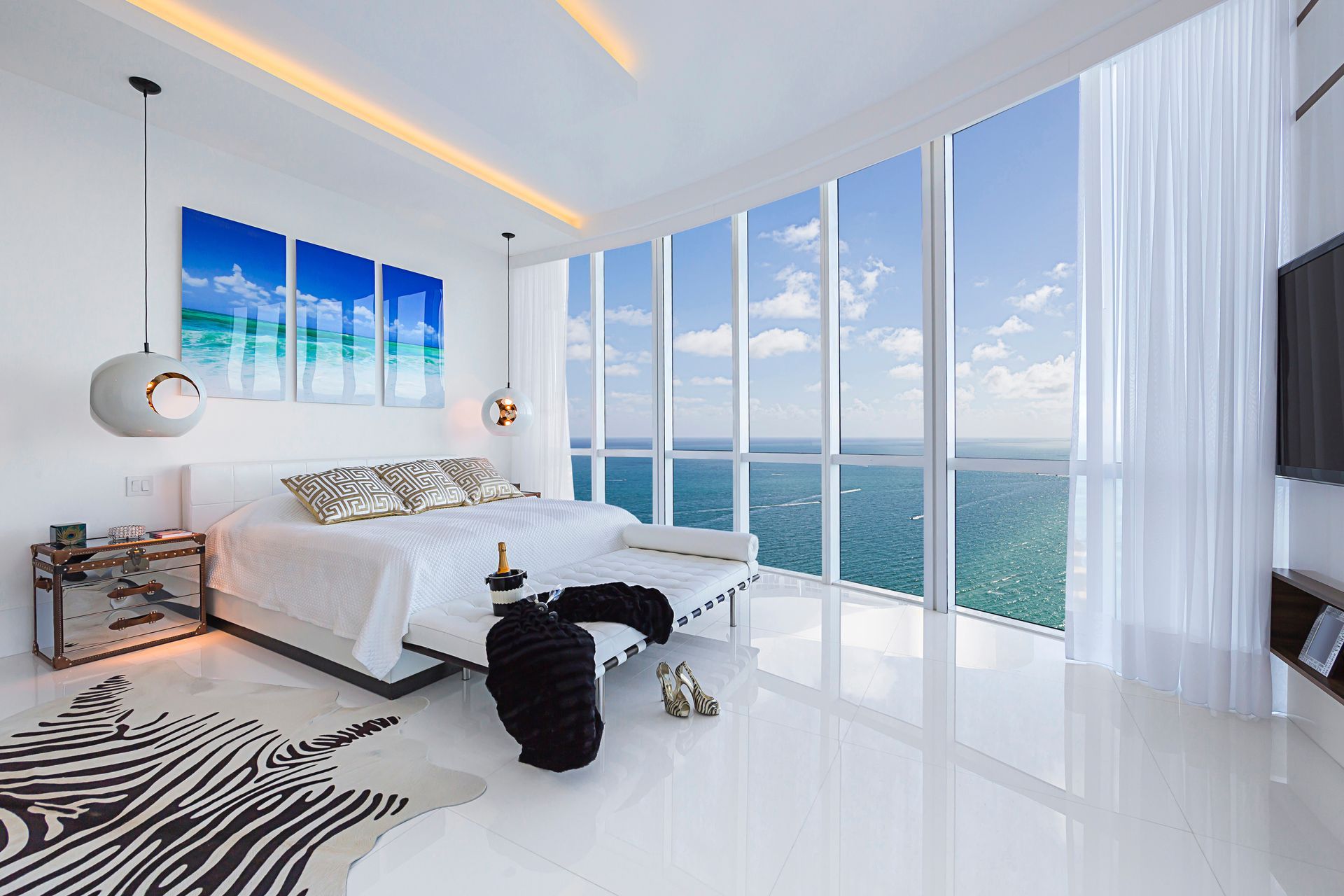 Luxury bedroom with floor-to-ceiling windows overlooking the ocean