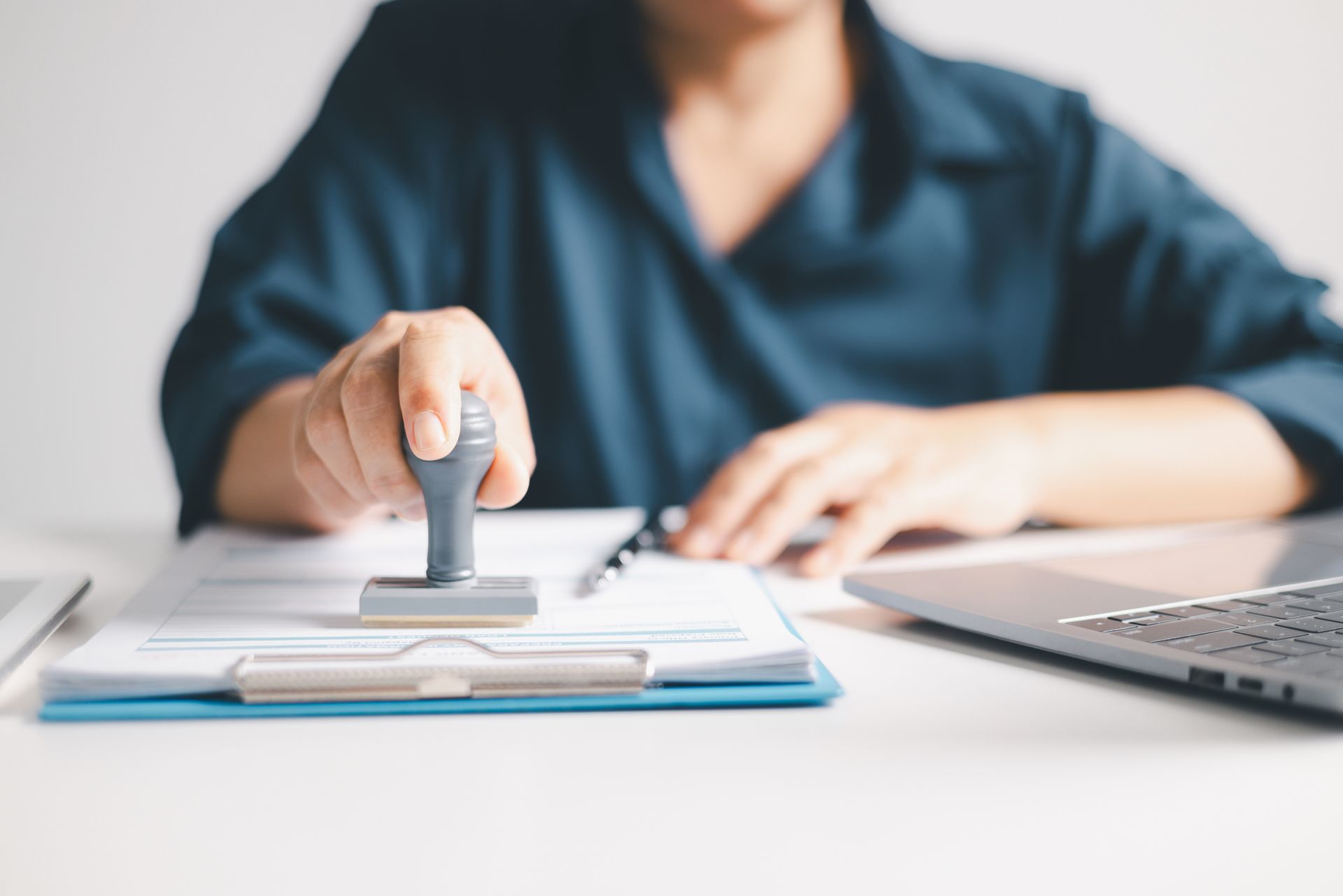 Agent using a stamp to approve official real estate closing documents