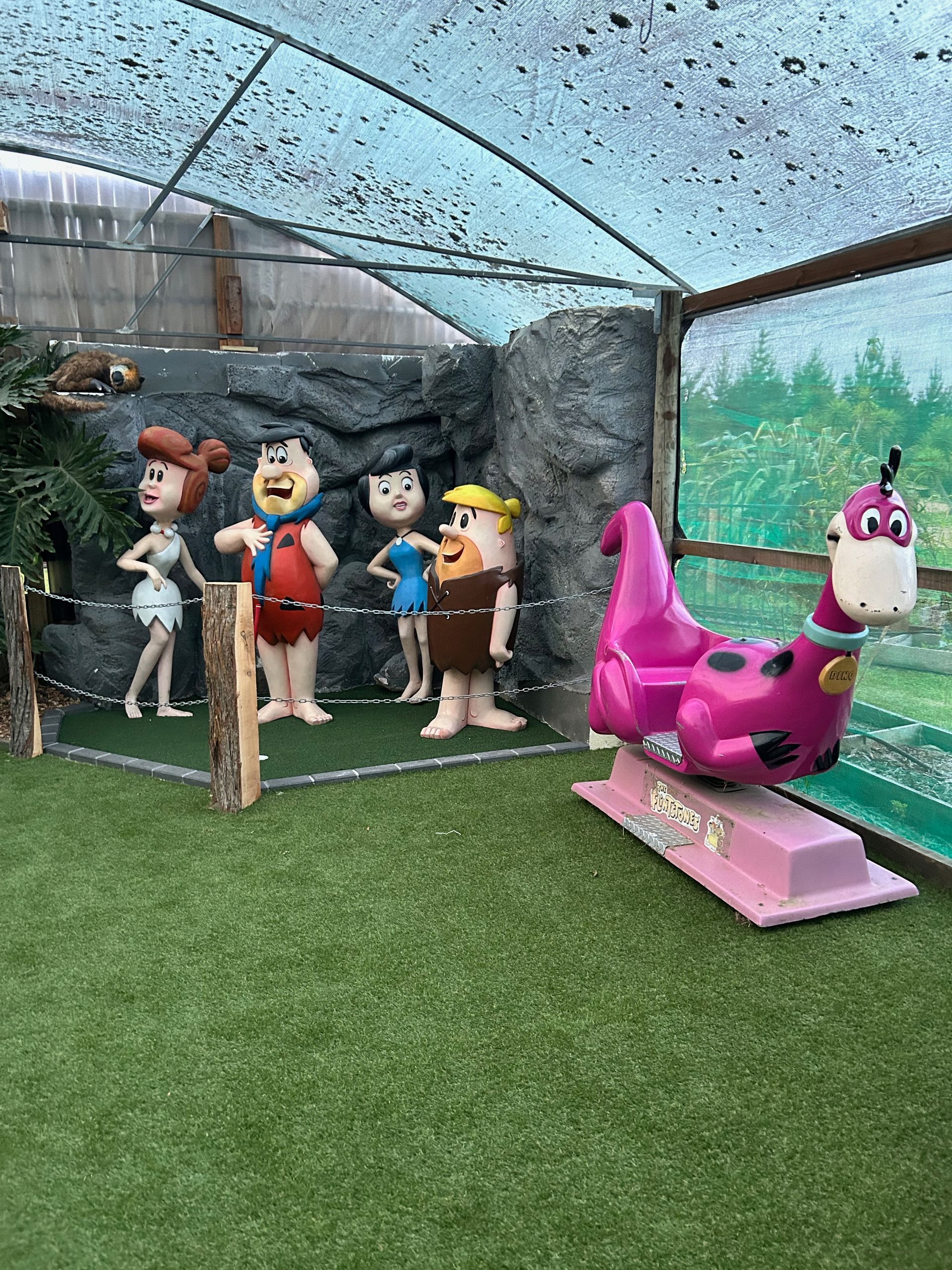 A group of cartoon characters standing next to each other in a greenhouse.