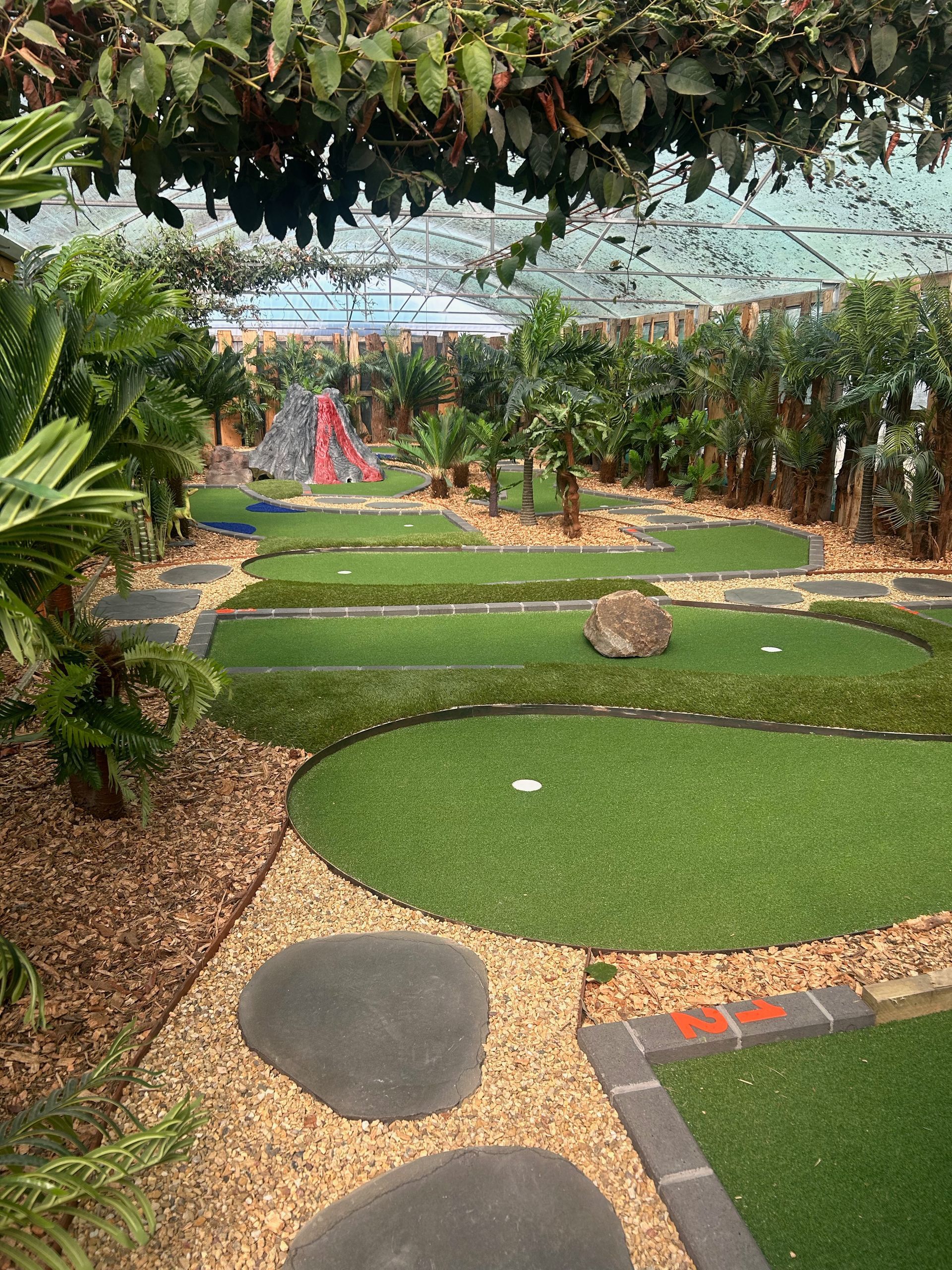 A golf course with a lot of green grass and trees