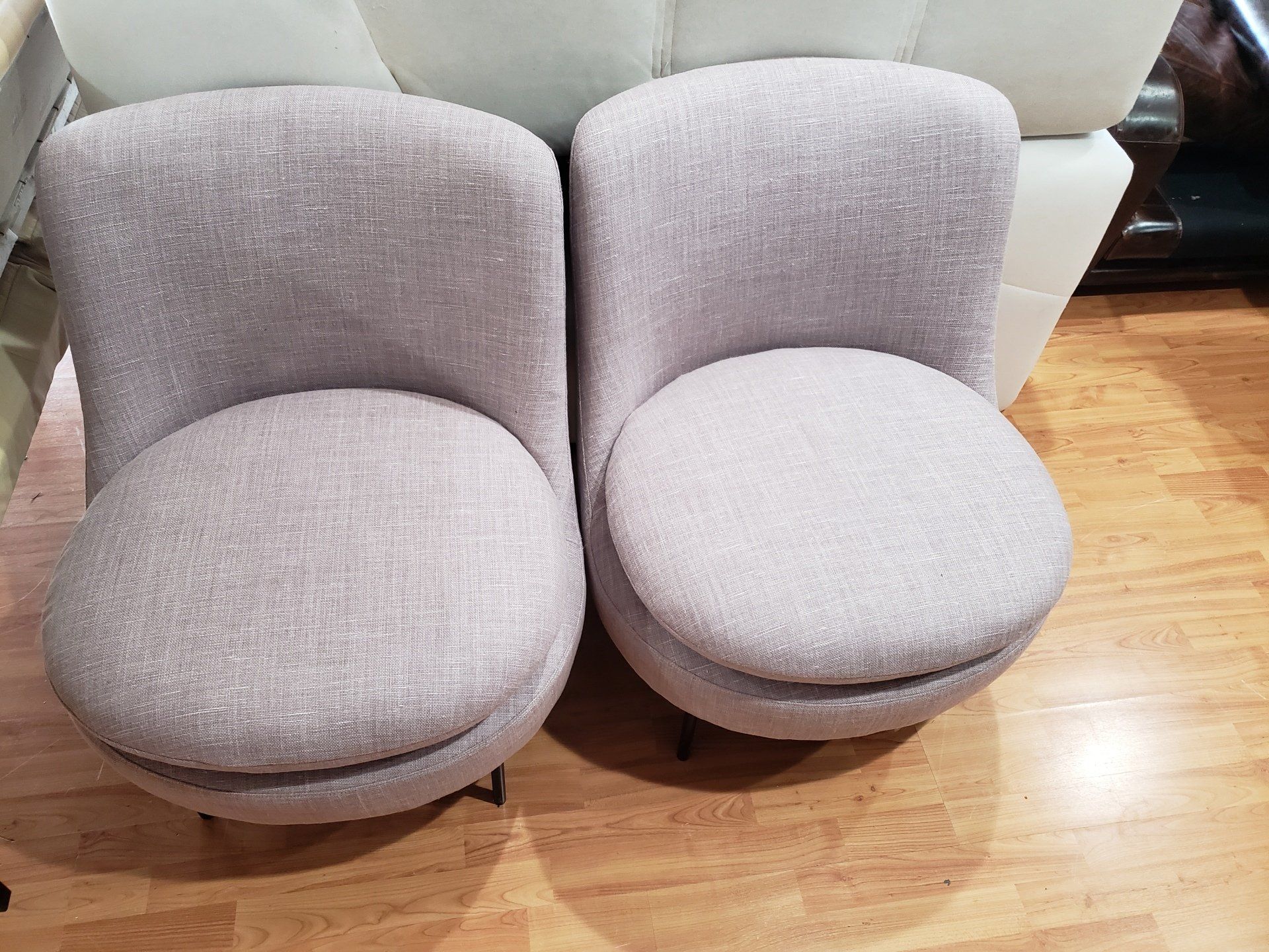 Two chairs are sitting next to each other on a wooden floor.