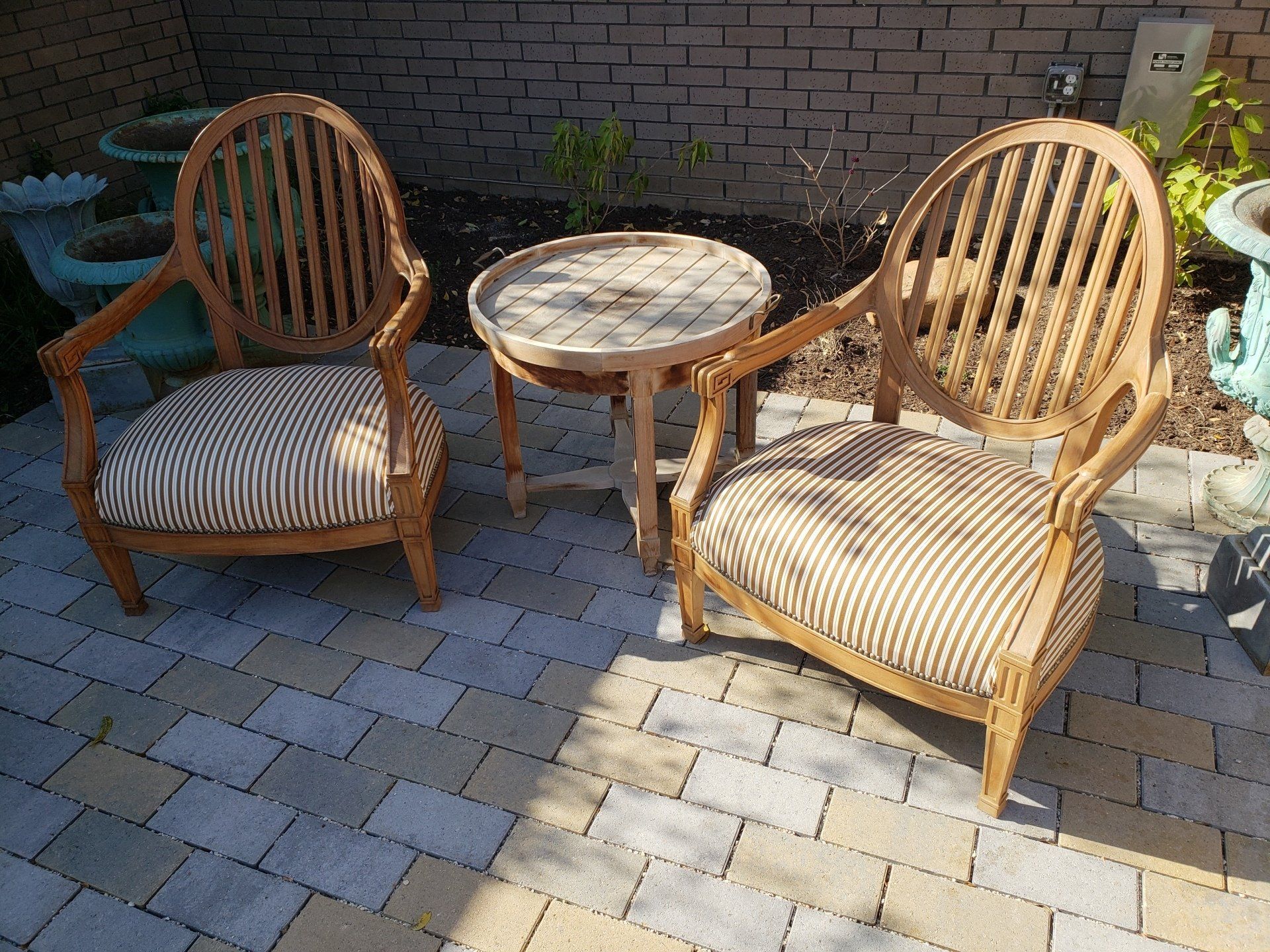 Two chairs and a table on a brick patio