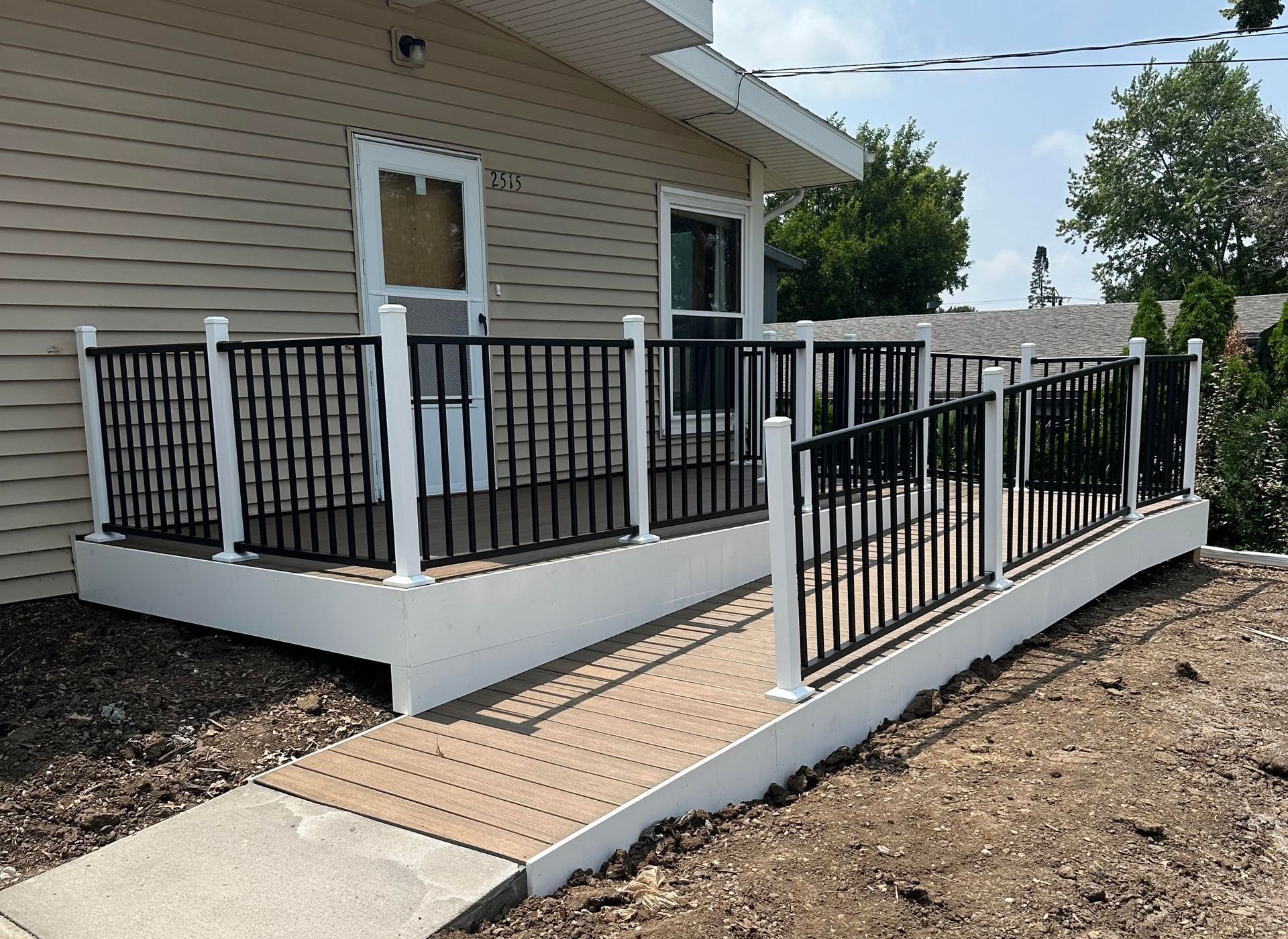 A wooden deck with an umbrella on top of it
