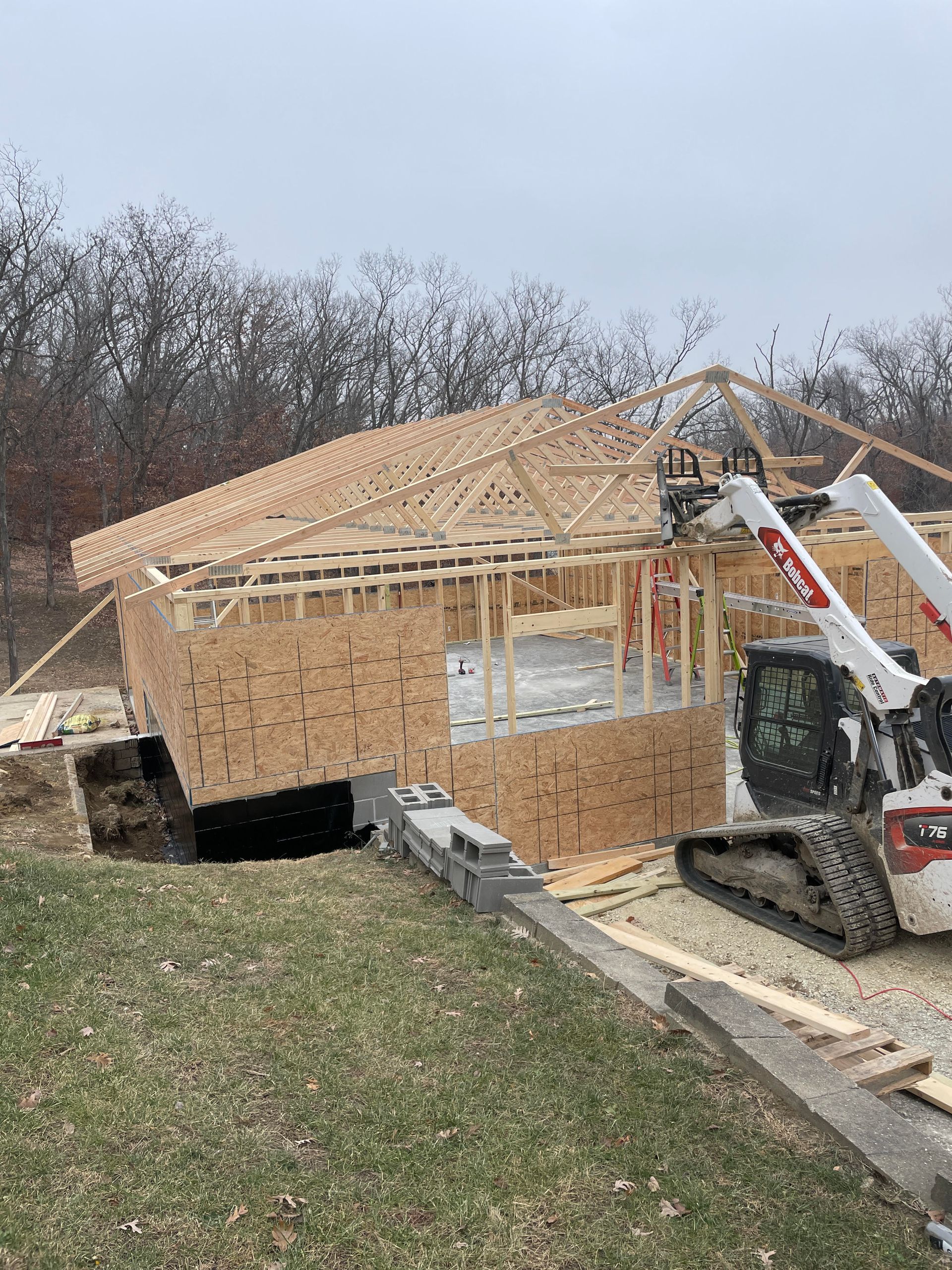 A room under construction with a large window overlooking the ocean.