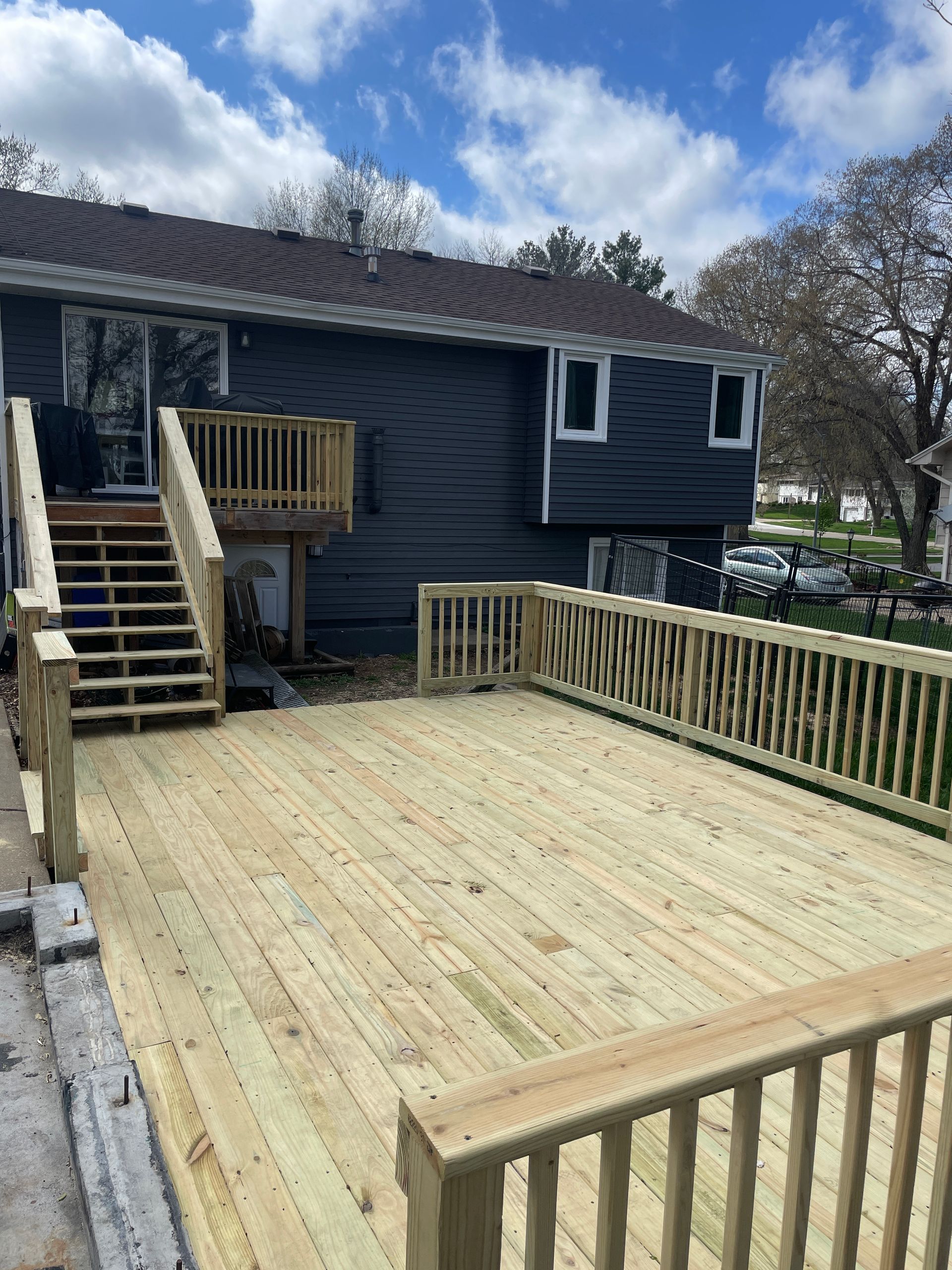 A man is using a drill to drill a hole in a piece of wood.
