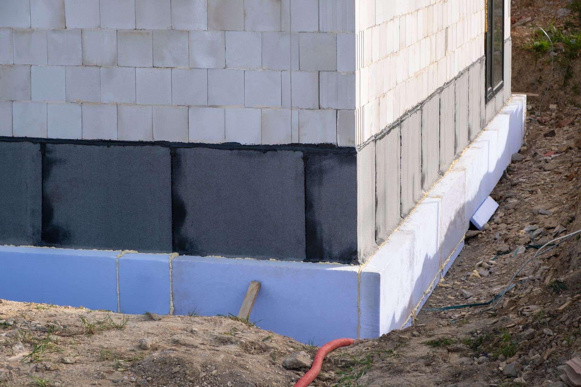 A building is being built with a blue foam foundation.