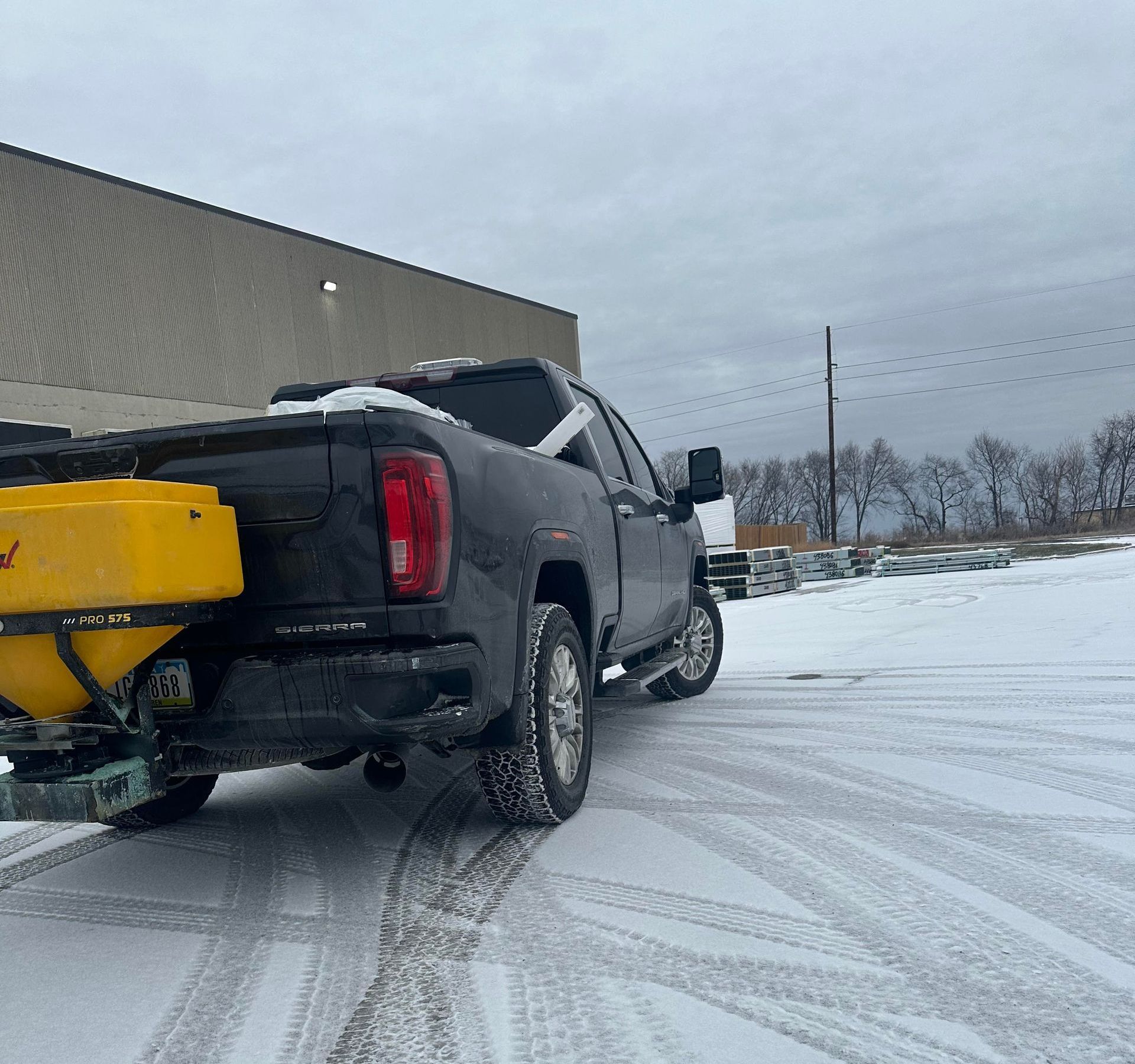 A person is shoveling snow from a sidewalk with a shovel.