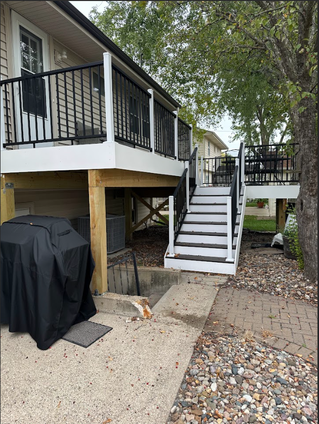A wooden deck with an umbrella on top of it