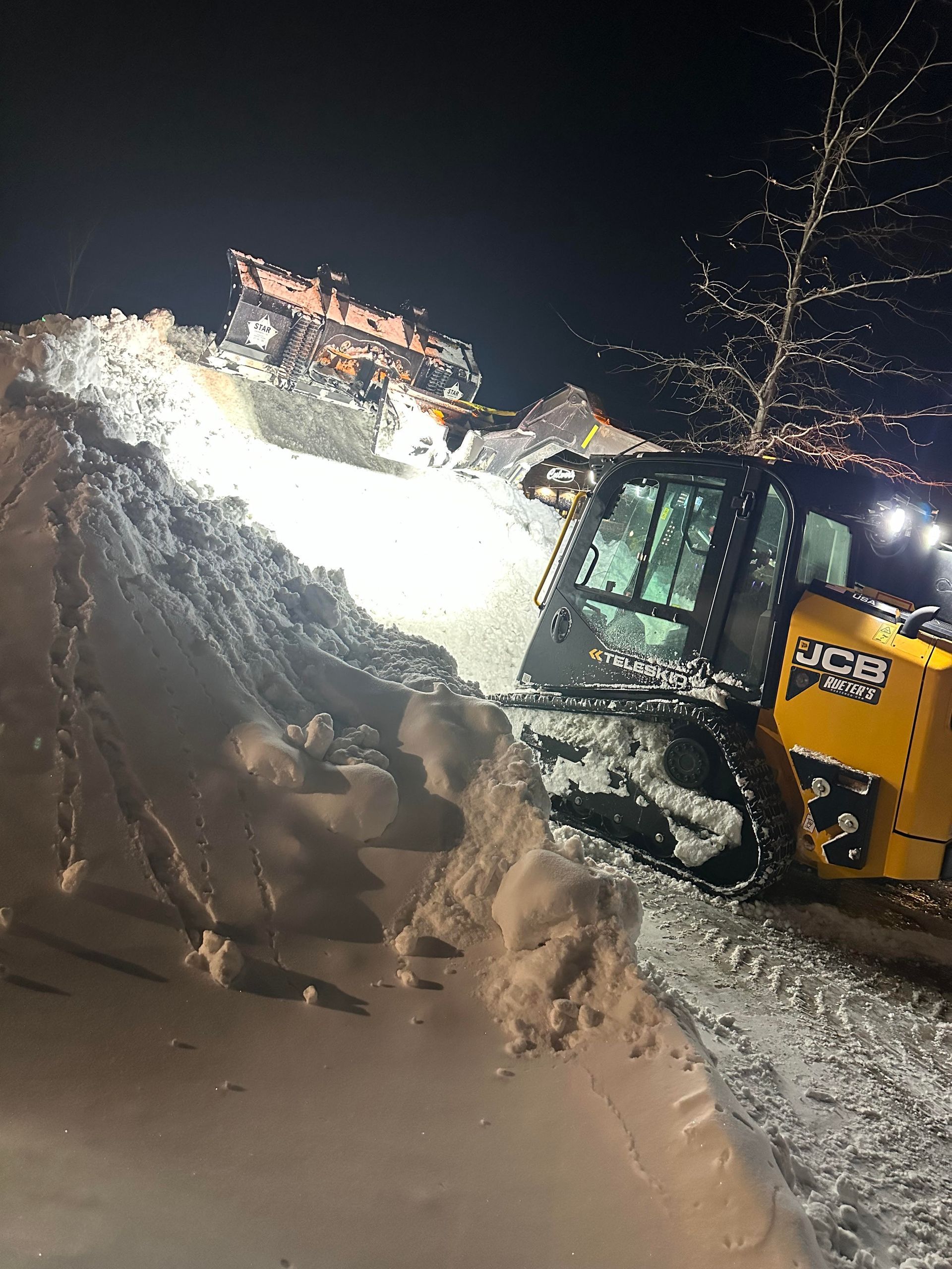 A man is using a snow blower to clear snow from a driveway.