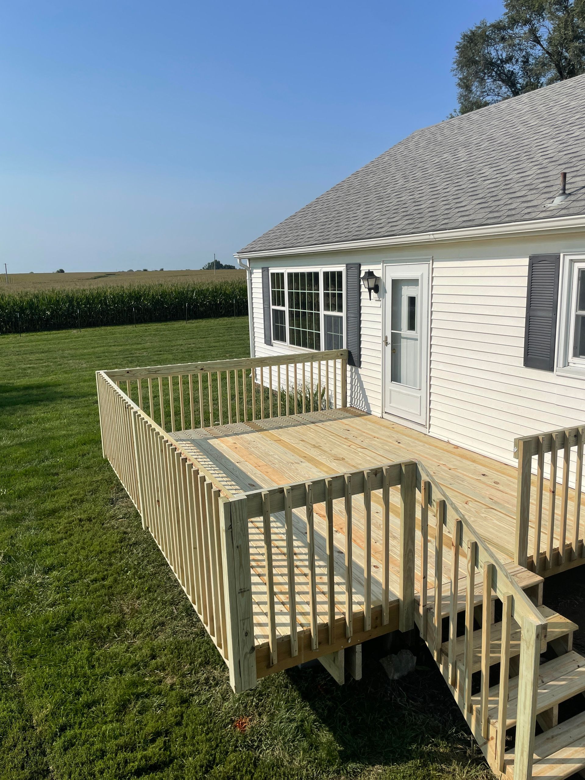 A man is using a drill to drill a hole in a piece of wood.