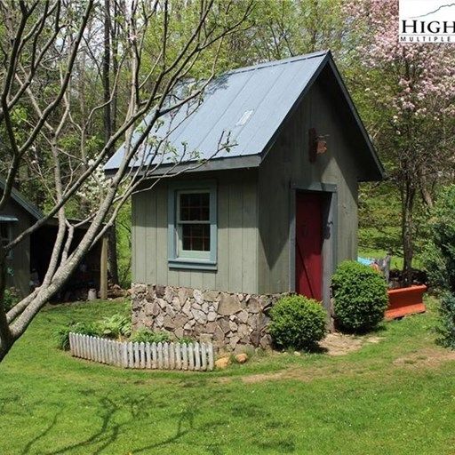 A small house with a blue roof and a red door