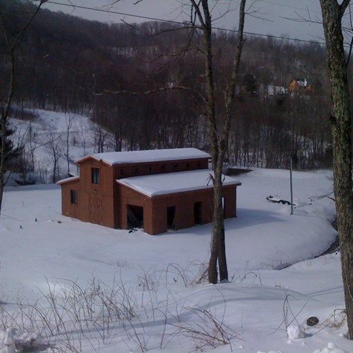 A house in the middle of a snowy field
