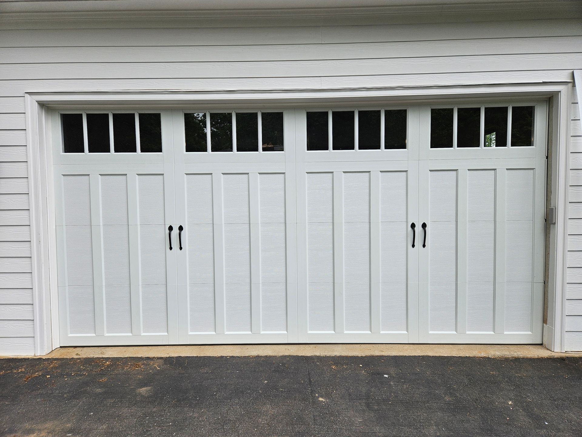 A white garage door with a lot of windows