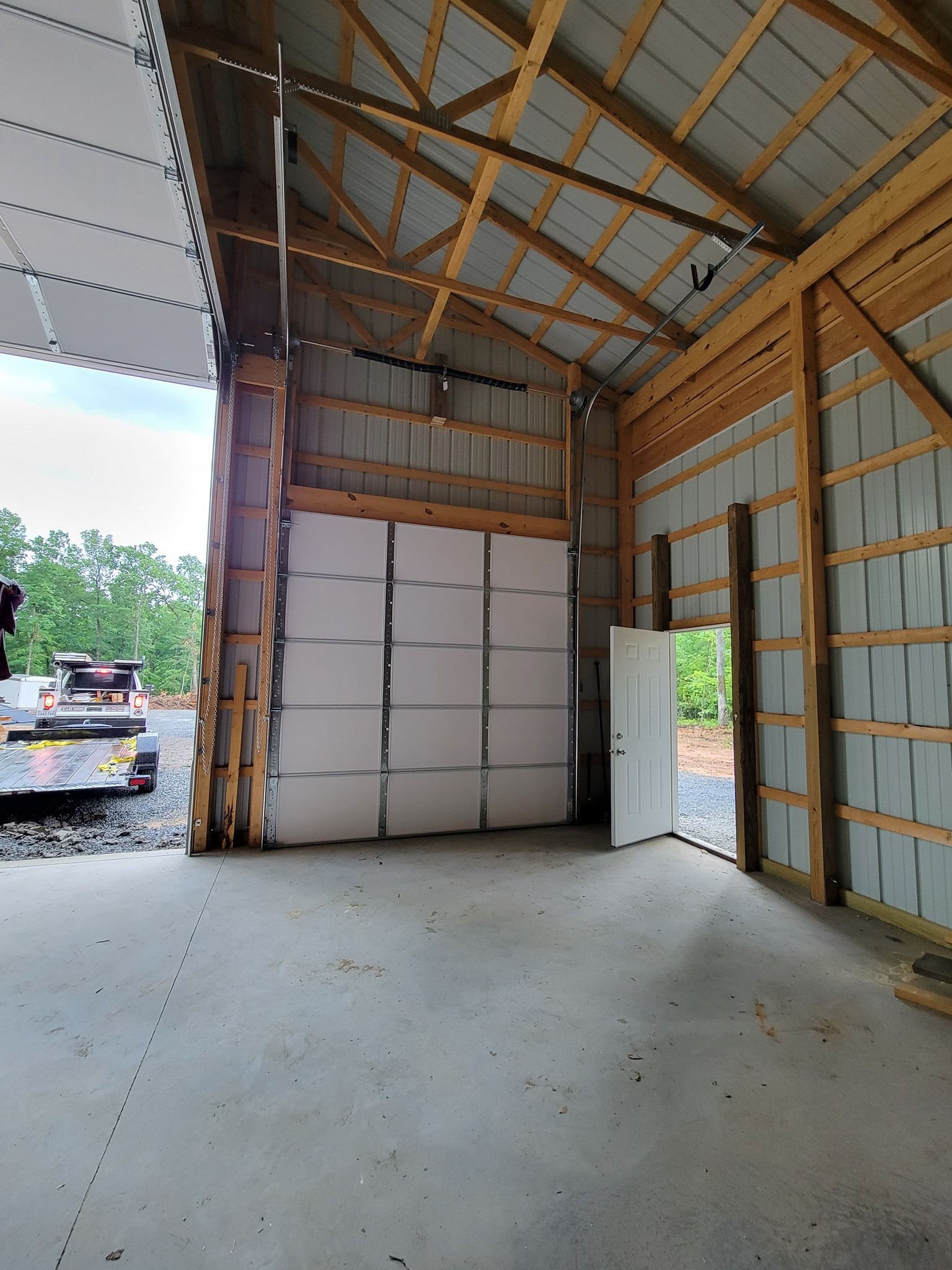 An empty garage with a large white garage door