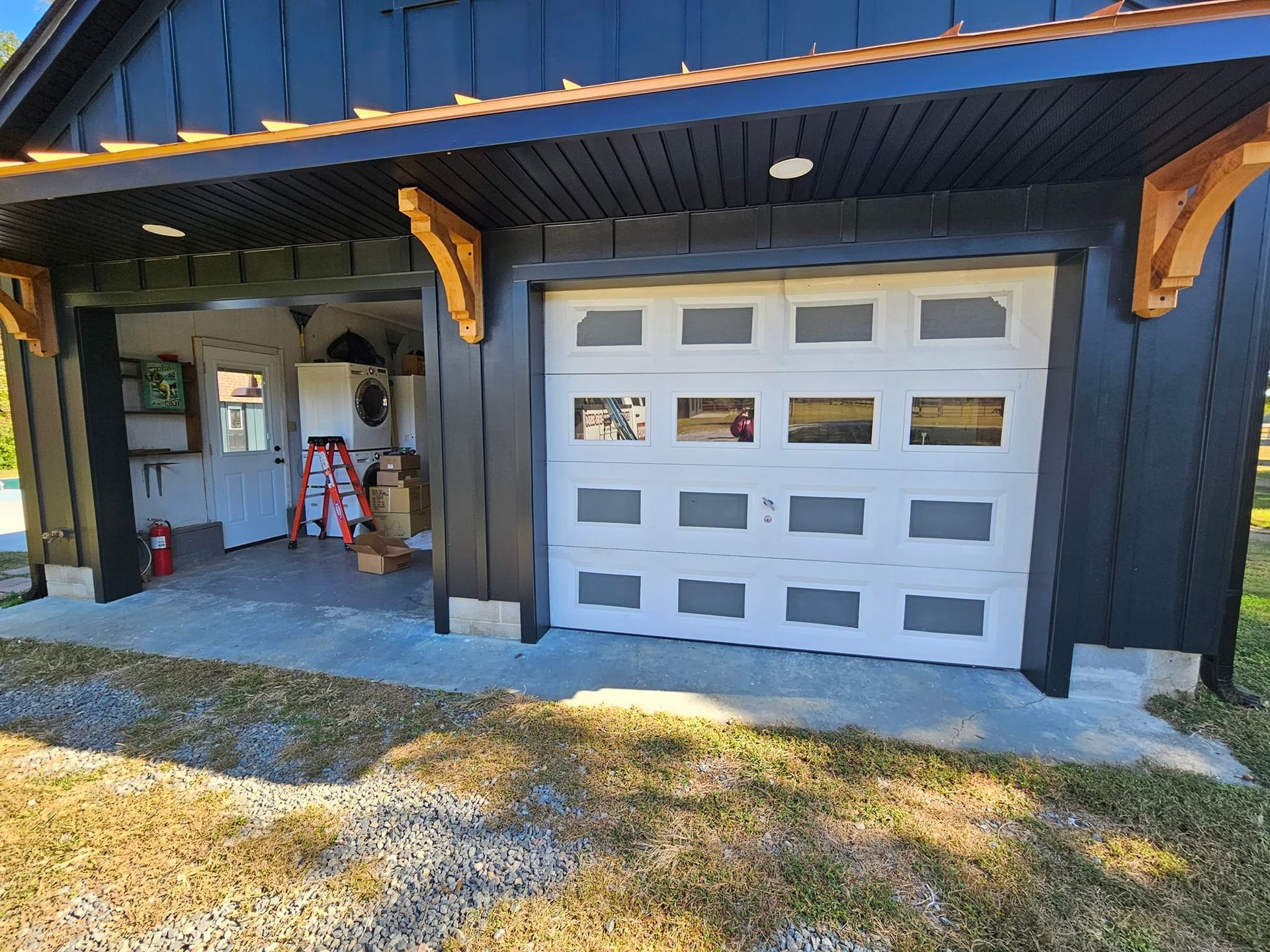 A black and white garage with a white garage door.