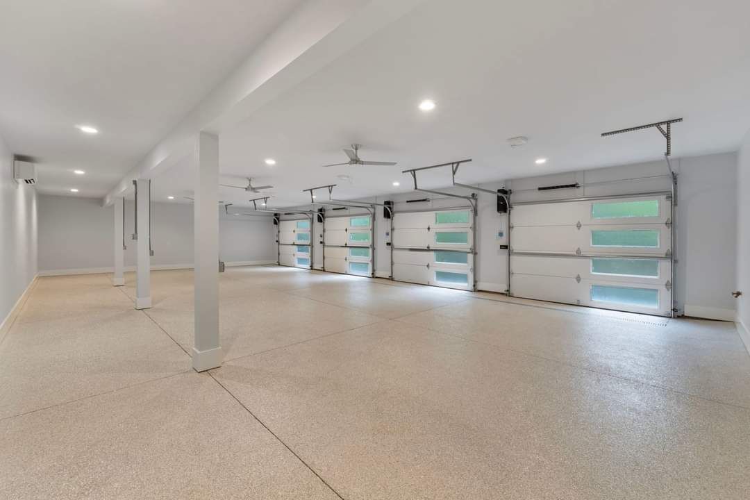 A large empty garage with a lot of garage doors.