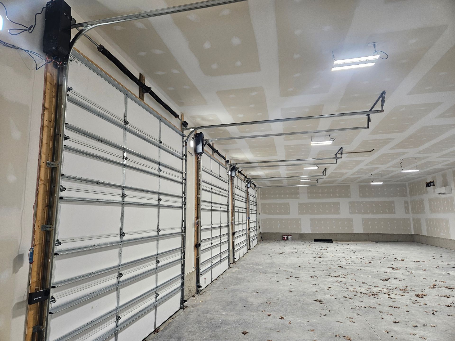 An empty garage with a lot of garage doors open.