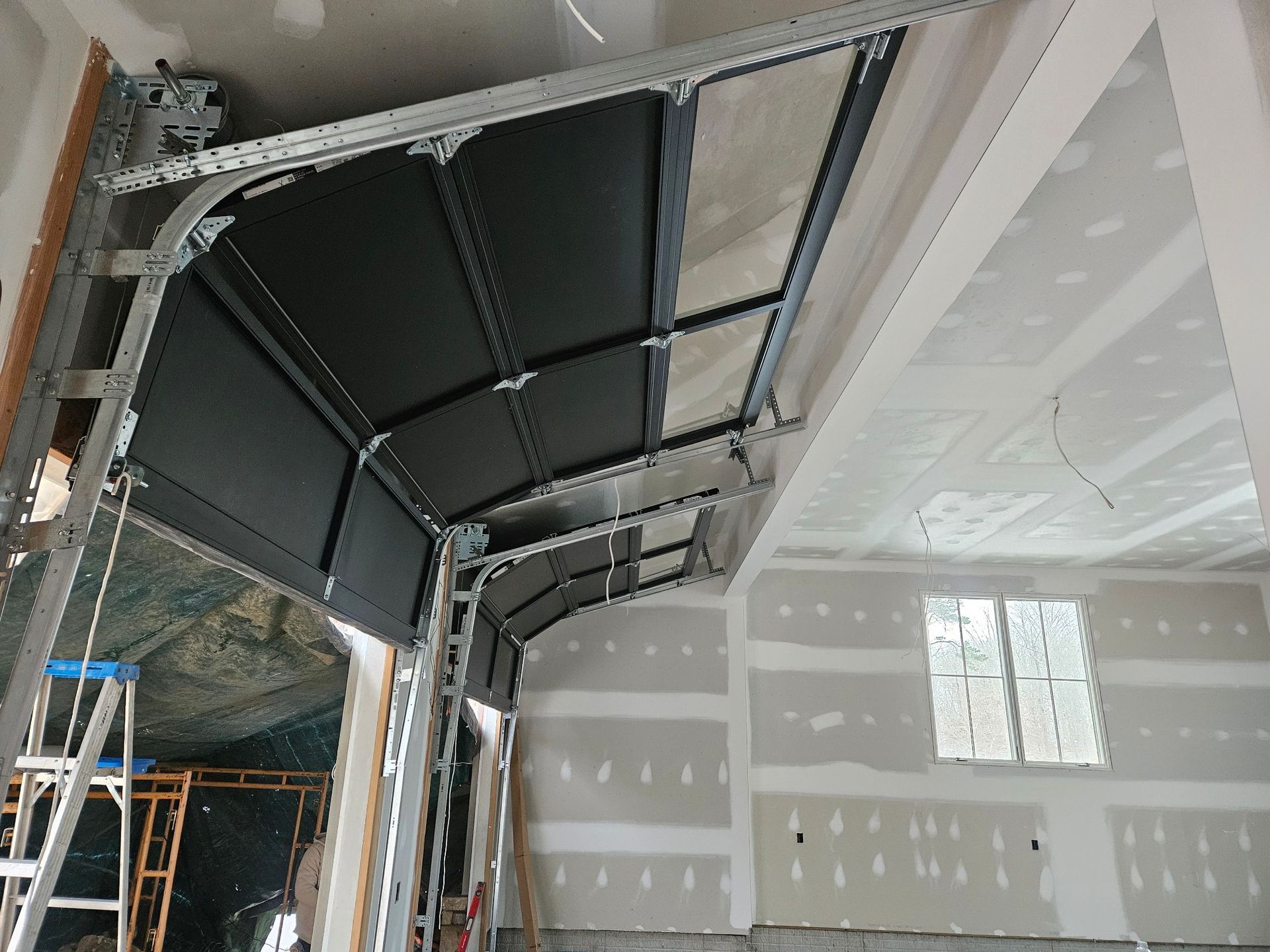 A garage door is being installed in a house