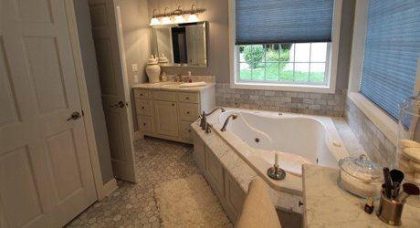 Bathroom Cabinetry — White Bathtub And Wooden Wall in Haven, PA