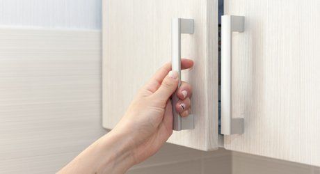Finishes — Female Hand Opening The Kitchen Cabinet in Haven, PA